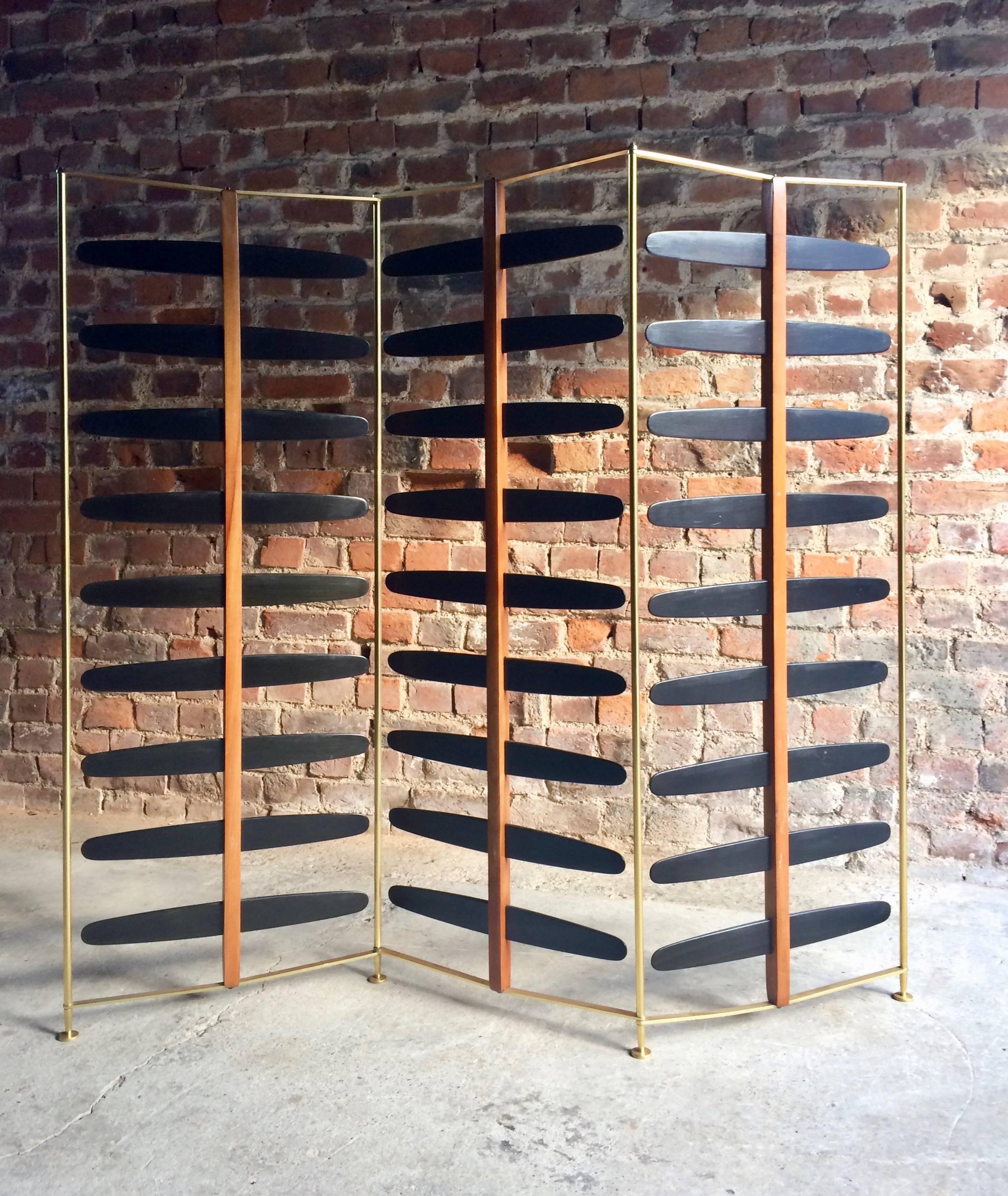 Magnificent midcentury three-section room divider or screen, probably of French design and origin dating to circa 1950s-1960s, brass three section frame with ebonised wooden wings to each section, very beautiful and extremely stylish.