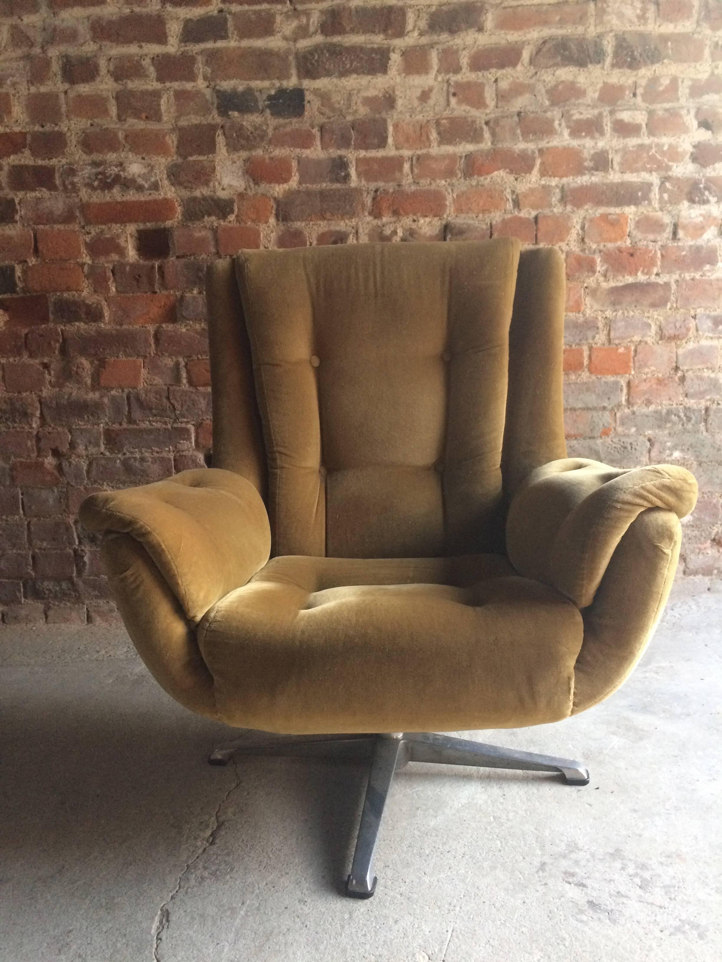 A fabulous midcentury 1960s high back armchair button back and upholstered gold velvet fabric, raised and rotating on a cast alloy base, extremely comfortable.