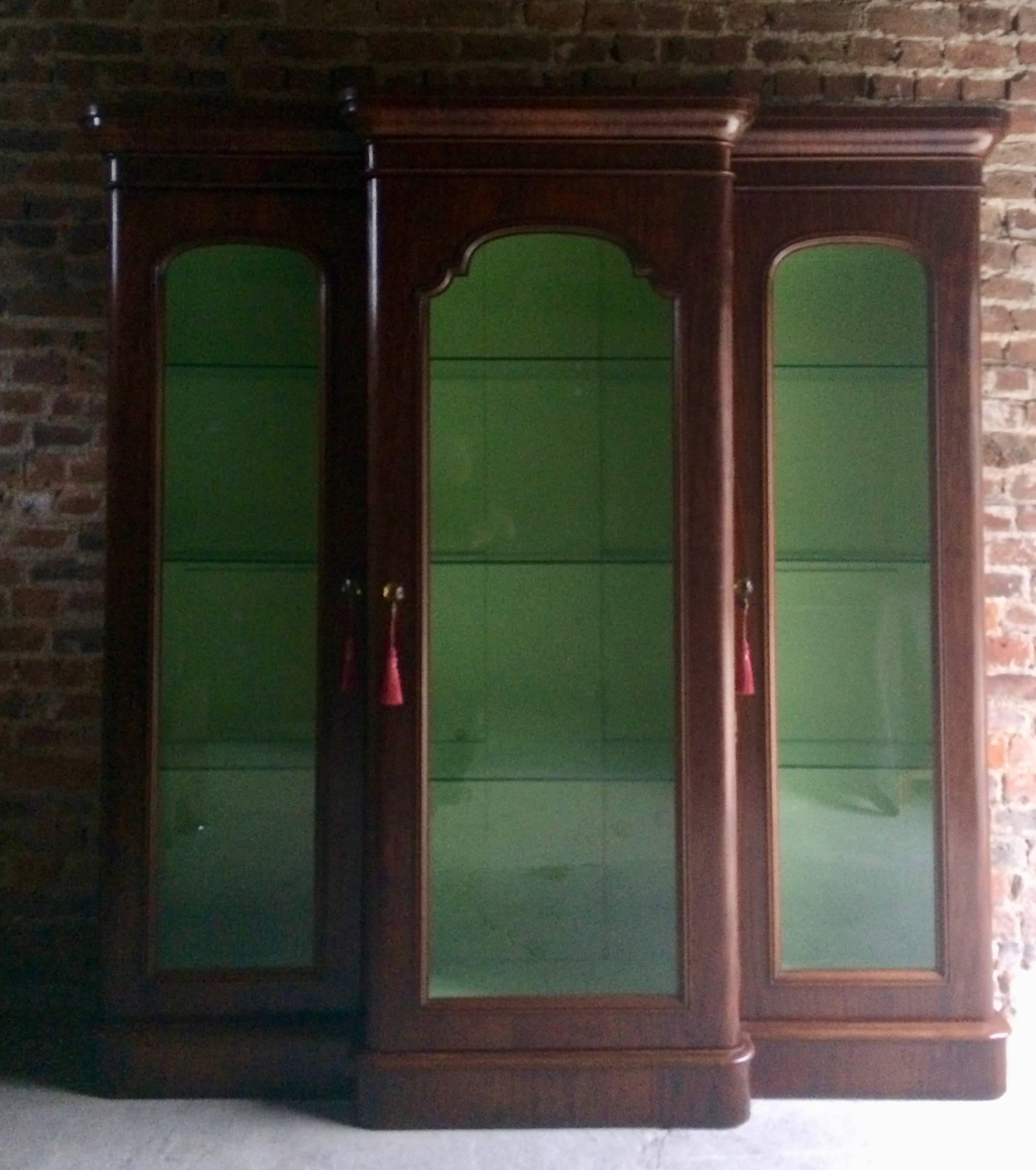 A fabulous large antique Victorian apothecary mahogany shop display cabinet vitrine, circa 1875, the. Corniced top over three glazed doors enclosing a green painted interior each with three glass shelves, comes with three non working keys and