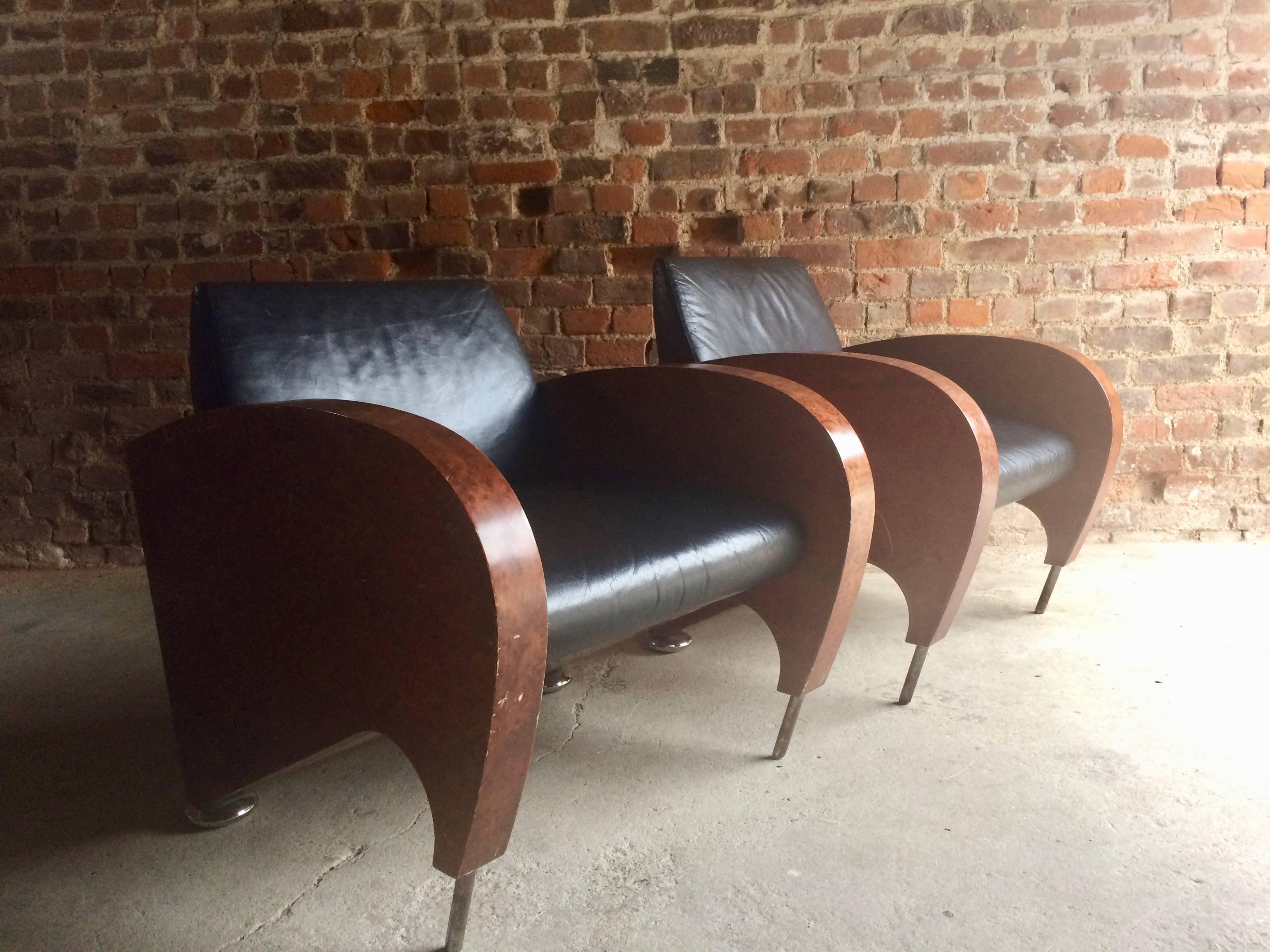 An outrageous and stunning pair of Art Deco walnut and black leather club chairs, circa 1940s, fabulous deco shaped and angled sides with chrome tube front legs and chrome bun feet to the rear, please note the leather on the chairs is in excellent