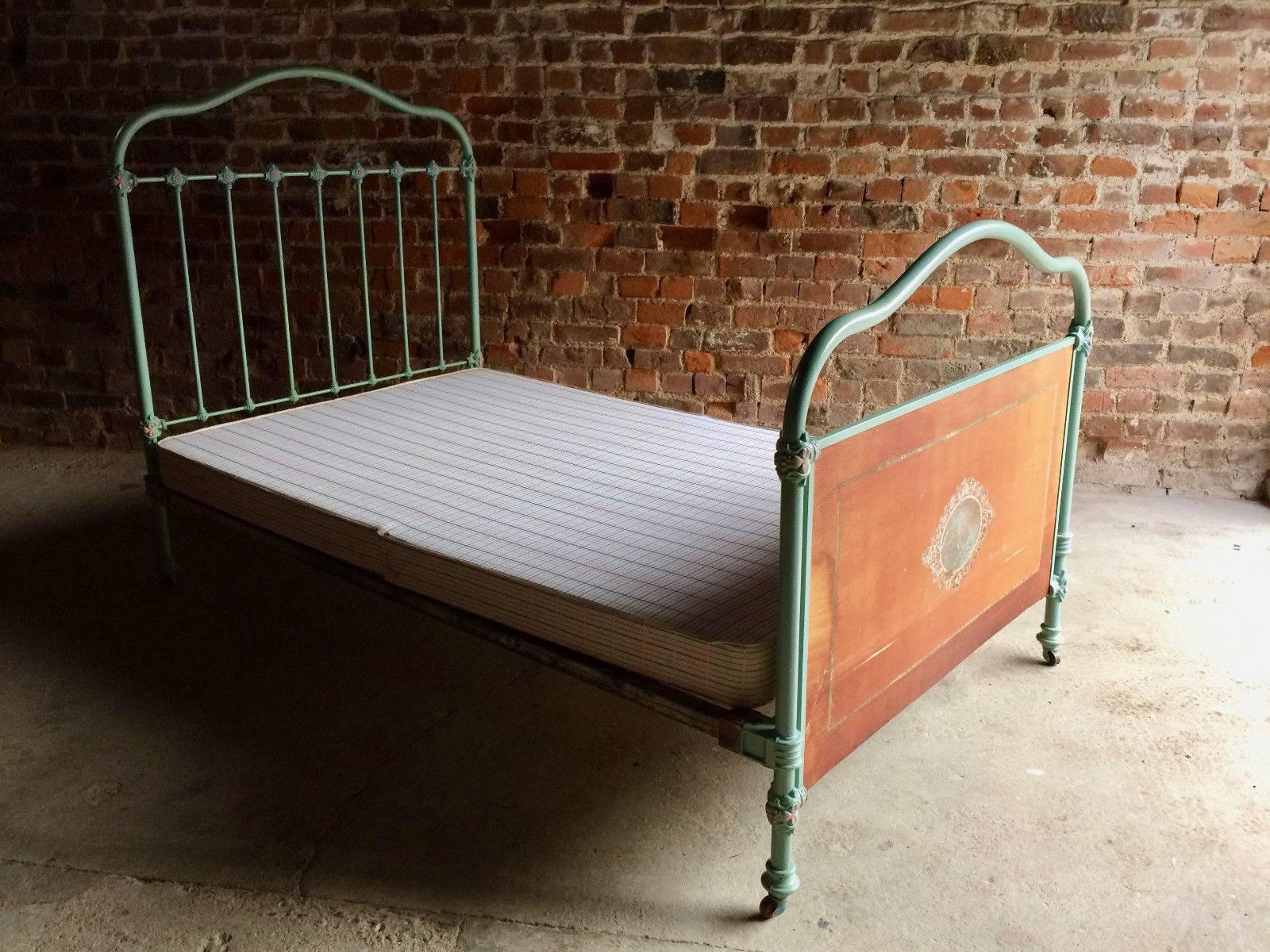 Stunning antique 19th century cast iron bed, teal color with red flowers raised on casters, comes with a single mattress resting on a divan, the bed comes apart and simply slots together, total six sections including the mattress and