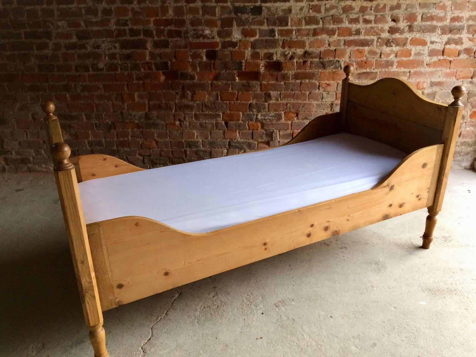 Antique, 19th century solid pine daybed, both ends with finials and raised on turned legs, comes with a single mattress and bed sheet resting on slats, the bed comes apart and simply slots together, total four sections including the mattress.