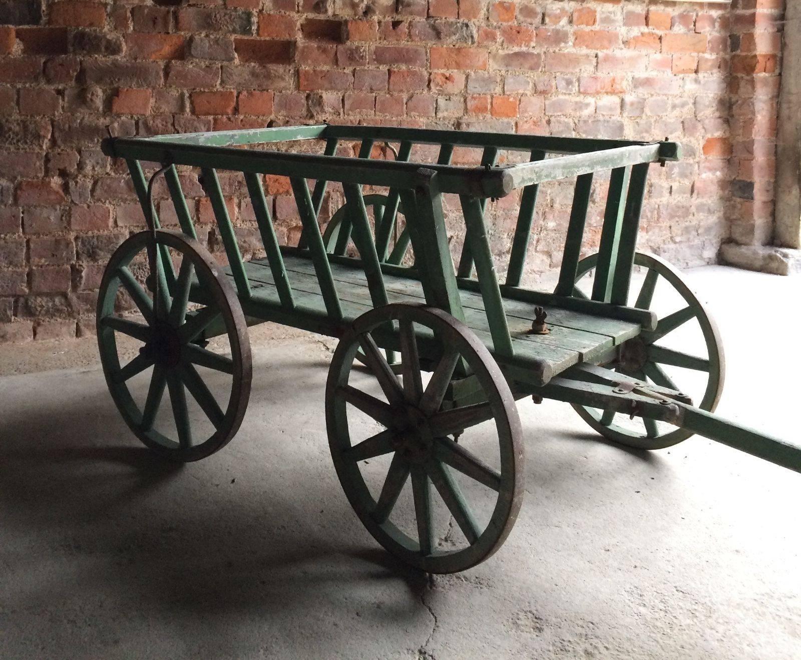 A beautiful and original 19th century French rustic dog cart or hand cart, circa 1870, the cart is offered in excellent original weathered and aged condition, the body made from oak with each wheel banded in iron, painted in original French