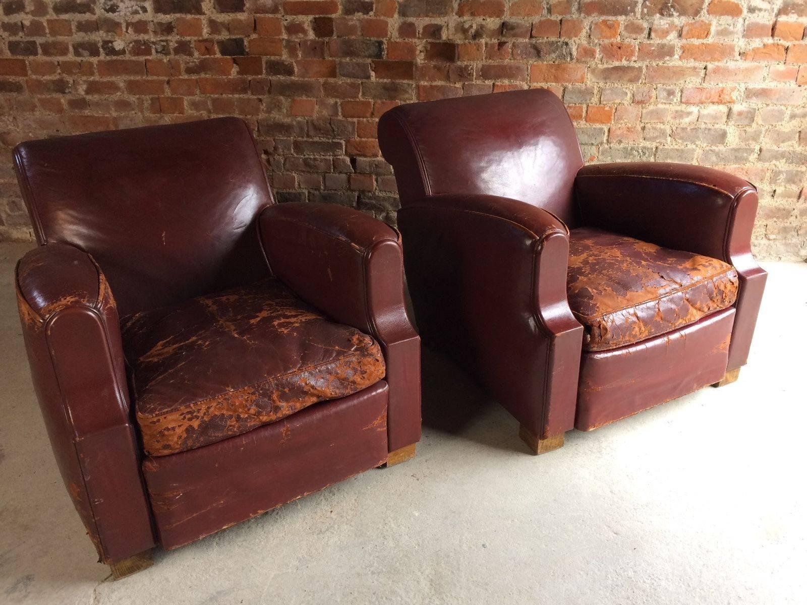 A pair of French Art Deco club chairs, circa 1930s, the chairs have an aged and worn look, finished in dark red leather, fabulous Art Deco lines and shape, extremely comfortable, and really heavy, looks amazing.