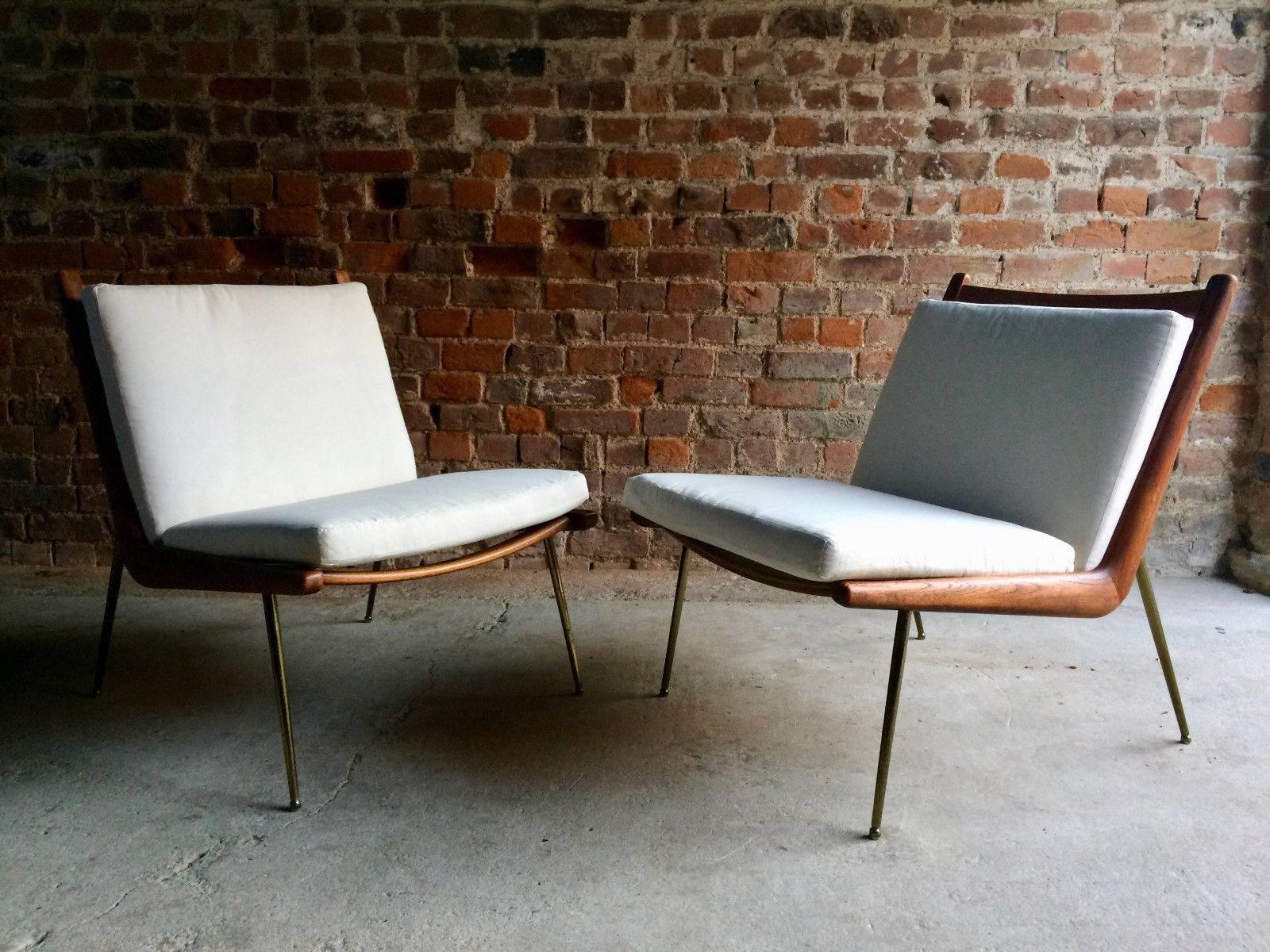 A pair of Boomerang chairs by Peter Hvidt and Orla Mølgaard Nielsen manufactured by France & Son, Denmark, the teak frames sit on brass plated legs with sabots, the cushions are covered in a white calico material that will need to be cleaned or