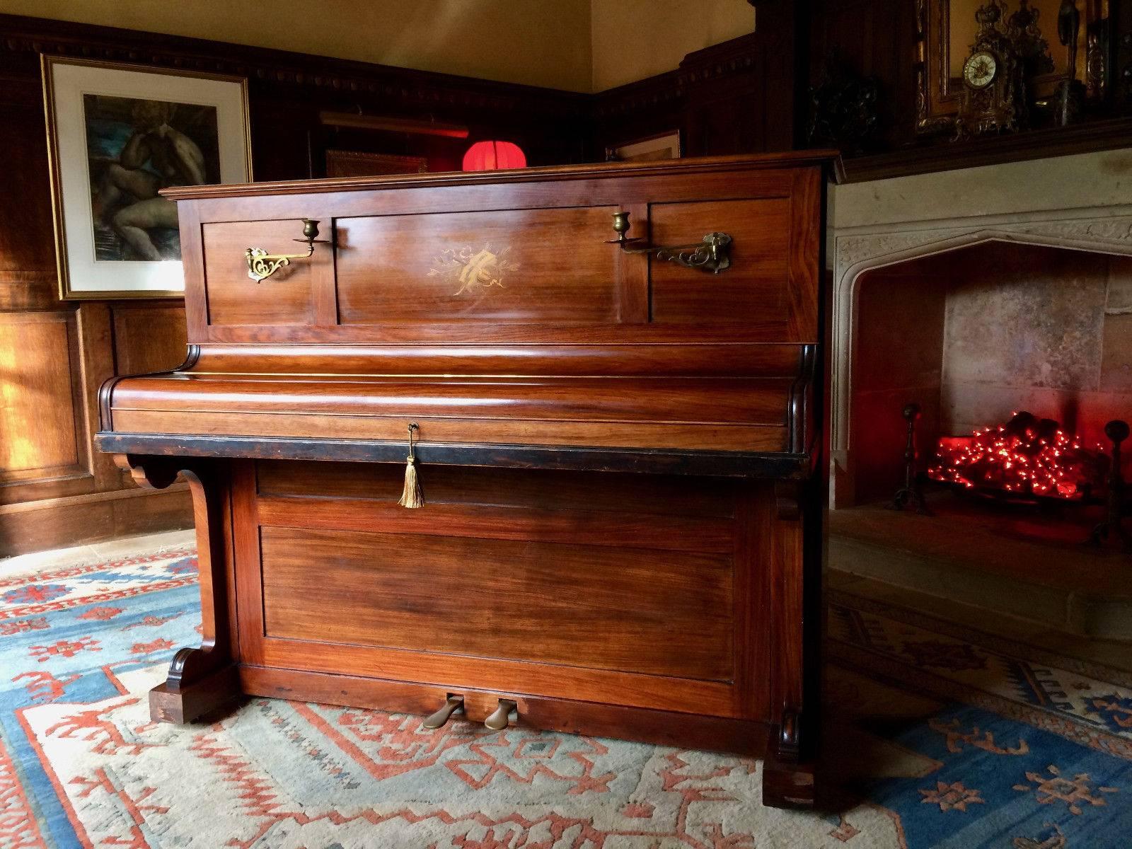 A fabulous antique 19th century Victorian inlaid rosewood upright piano by John Broadwood & Sons of London circa 1875, with fold away drop down music sheet holder, brass candle holders and brass pedals, the piano is offered in superb condition with