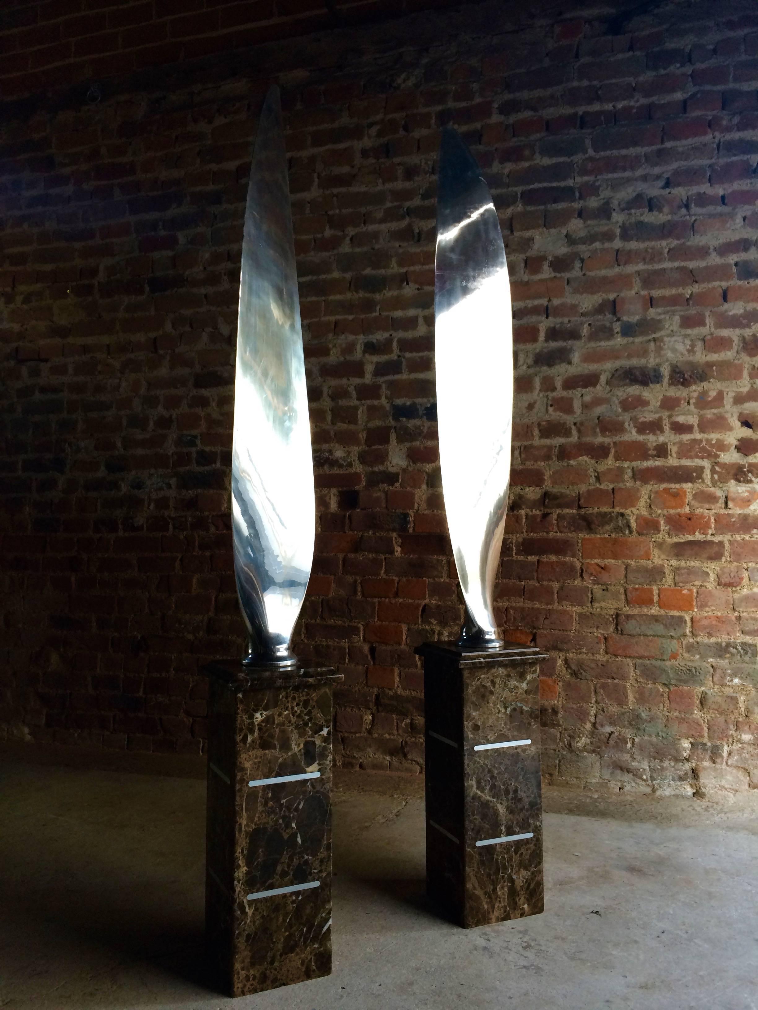 A stunningly beautiful unique and one of a kind pair of chrome Airplane Propeller Blades, each highly polished to mirror effect, both supported on marble standings. Very decorative as modernist sculptures, for display or collection use only, the