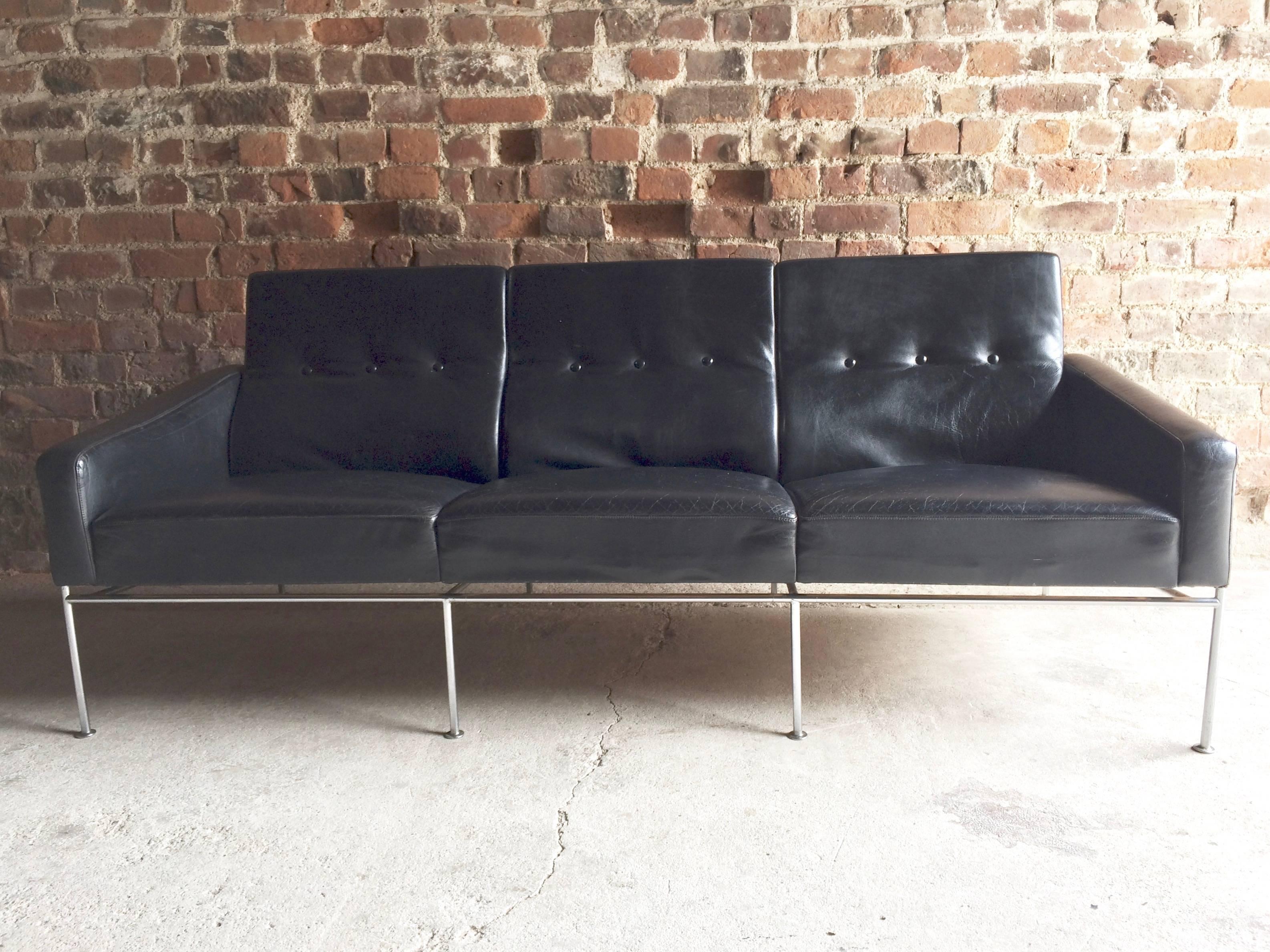 A stunning 1960s model 3300, three-seat black leather sofa, designed by Arne Jacobsen, manufactured by Fritz Hansen with chrome supports offered in superb original condition.

Arne Jacobsen got the inspiration for the series 3300 from a sofa he