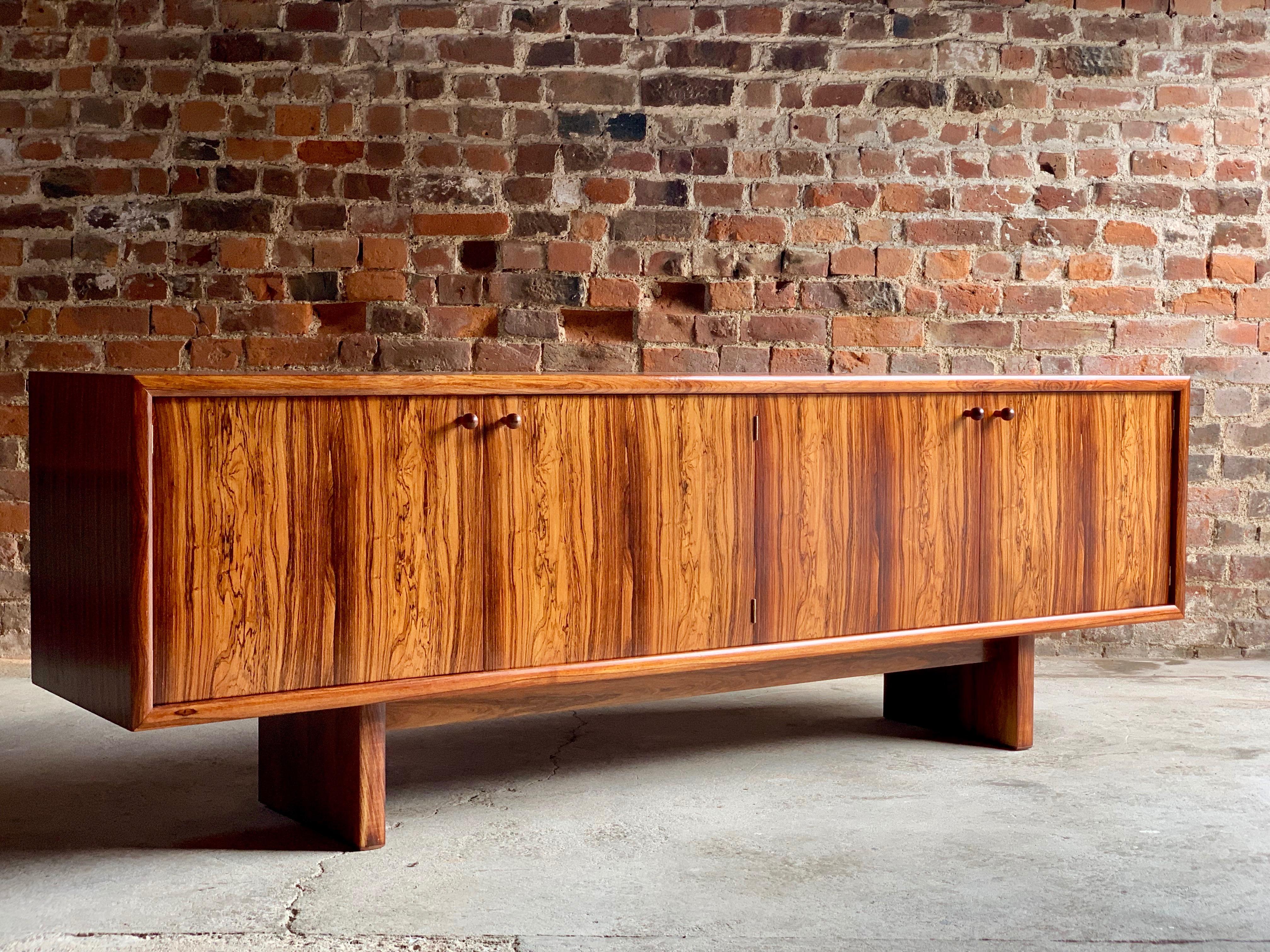 Gordon Russell 'Marlow' rosewood sideboard credenza designed by Martin Hall for Gordon Russell Ltd of Broadway, material: Figured rosewood - date: 1970s, the rectangular top with beautiful repeating rosewood pattern over four cupboard doors, shelves