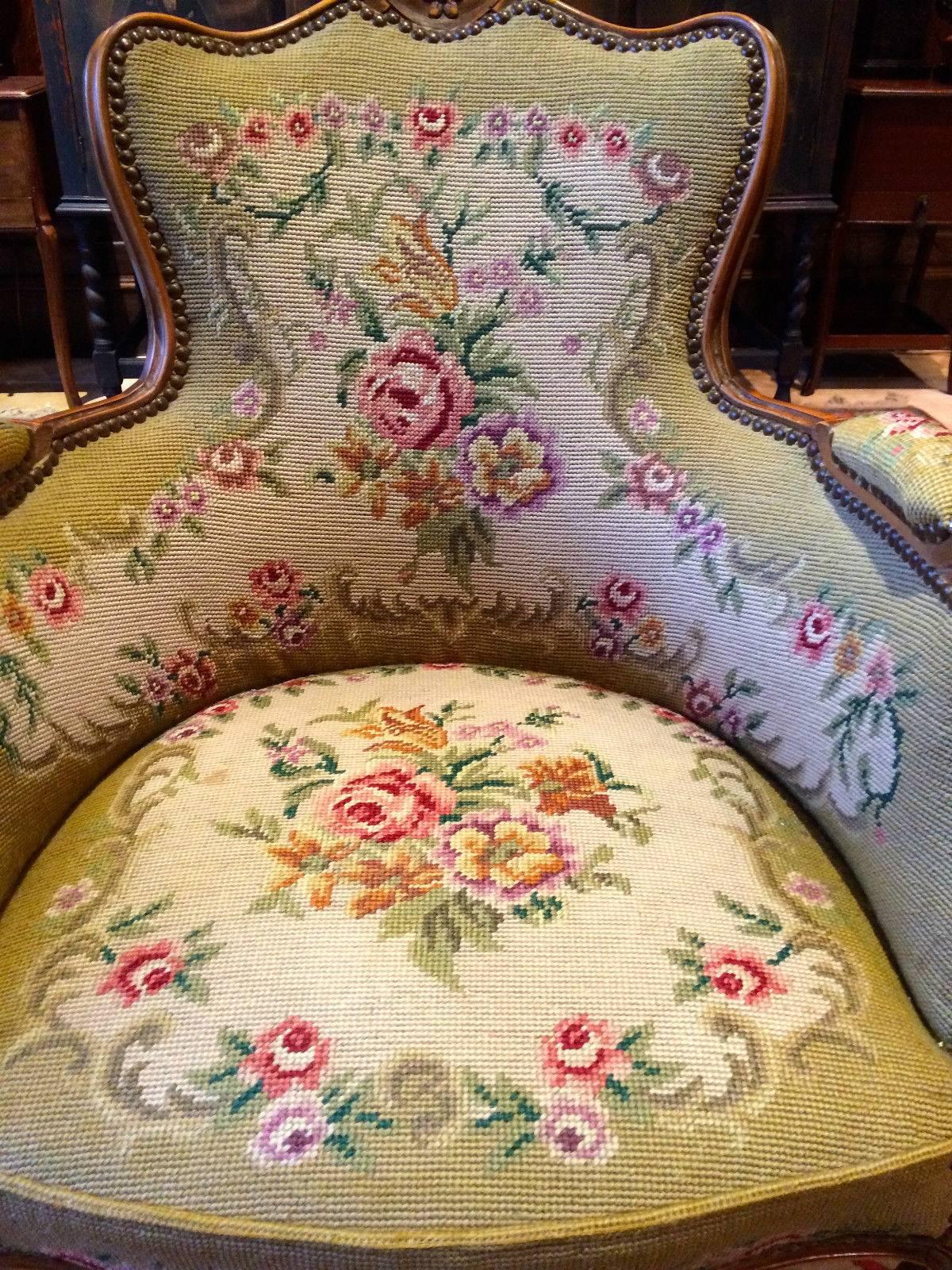 A beautiful antique French Mahogany salon armchair with stuff-over arms and seat with near matching footstool, upholstered in floral needlework ‘Roses’ with gold velvet back, scrolled arms, standing on elegant cabriole legs, the armchair is offered