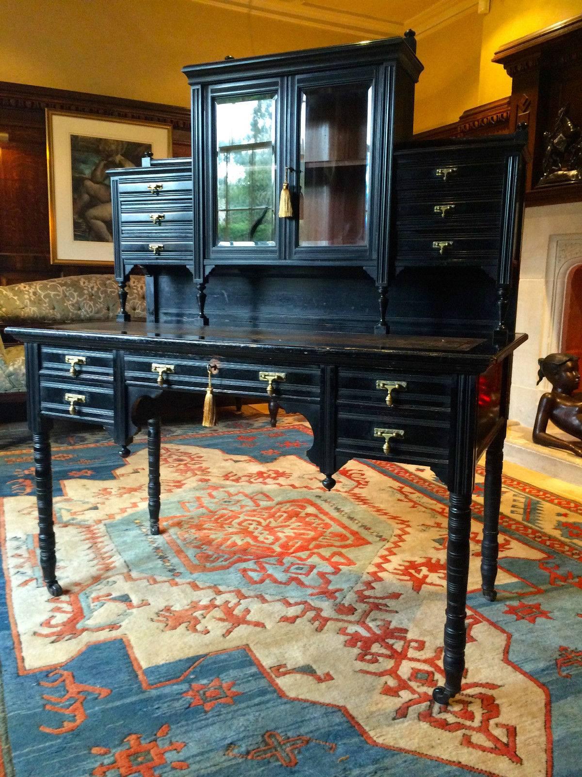 A sublime and truly beautiful aesthetic period Ebonised Mahogany ‘Bureau de Dame’ by Robert Strahan & Co, Dublin, circa 1885, the back with bobbin turned rail over to bevelled glass panels doors opening to shelf, flanked on either side with three