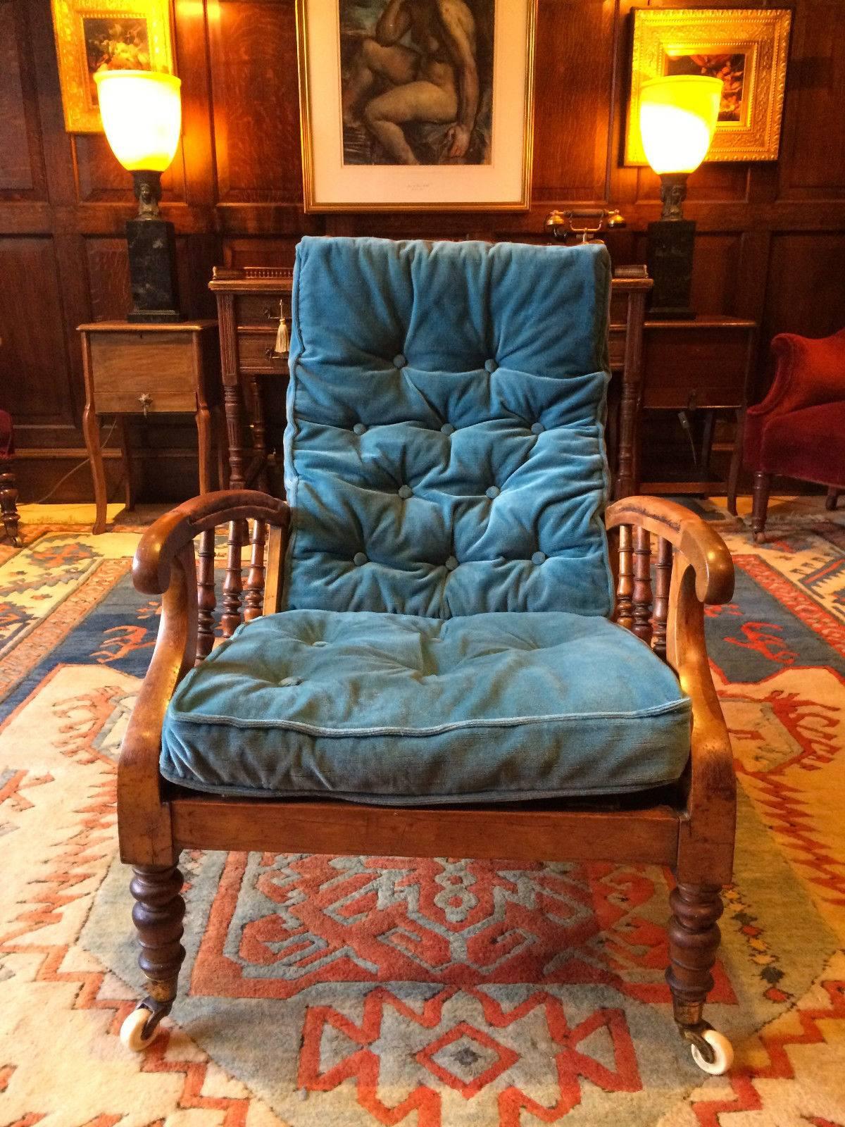 A beautifully elegant with sweeping design early 19th century Regency period Satin Birch reclining armchair dating, circa 1811, spindle back and arms, with four adjustable seating positions with two Blue button back horse hair filled cushions that