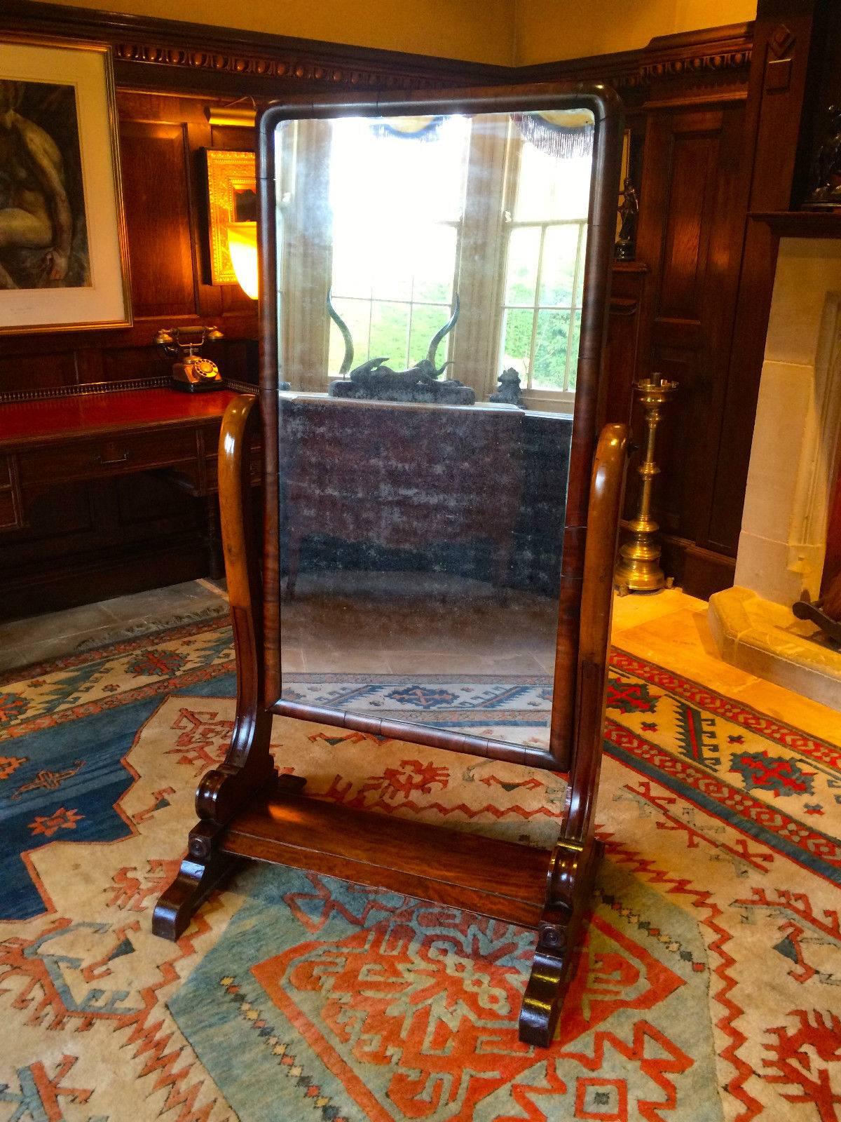 Antique early 19th century Victorian Mahogany Cheval mirror, full length rectangular mirror, supported by elegant scrolling arms, on four short turned feet united by platform stretcher, the mirror has a wonderful aged appearance with a mottled