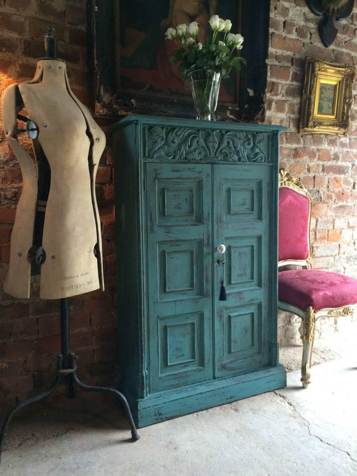 A 'French Painted' antique 19th century two-door carved hall or bathroom cupboard, the moulded dentil cornice over two paneled cupboard door enclosing two shelves, comes with one key and tassel (non working), finished in a teal chalk paint, dark