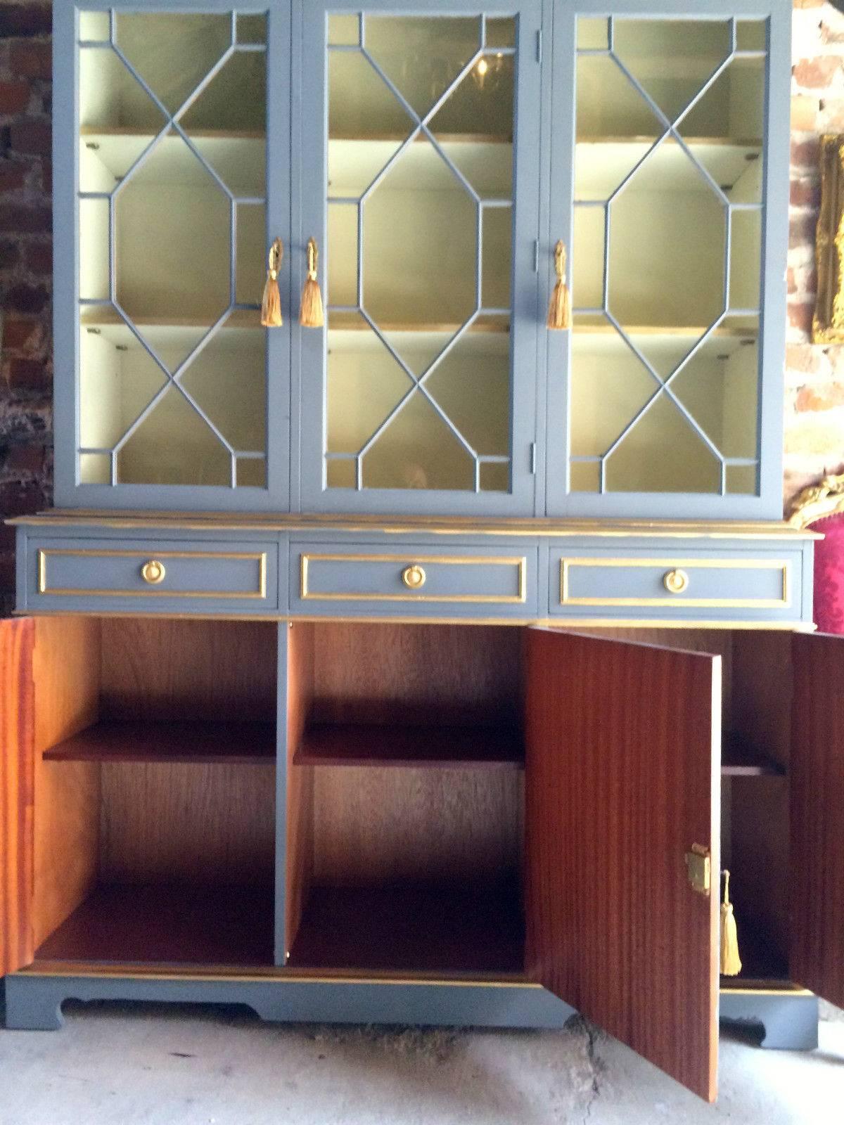 A bespoke French painted Georgian style mahogany triple fronted bookcase, the upper section with three glazed doors with six adjustable shelves, the lower section with three drawers over three cupboards, comes with six working keys and six tassels,