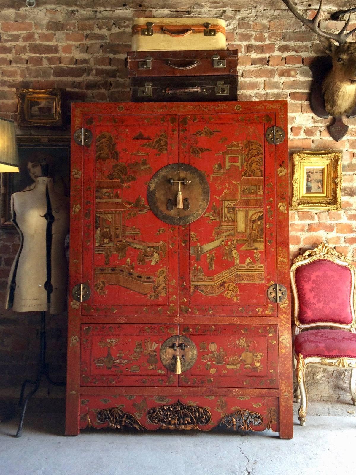 A stunningly beautiful Chinese Shanxi scarlet and gold lacquered wardrobe, richly decorated with figures in pavilion settings, with decorative lock plates, the upper section with two doors with single removable shelf with two small drawers below,