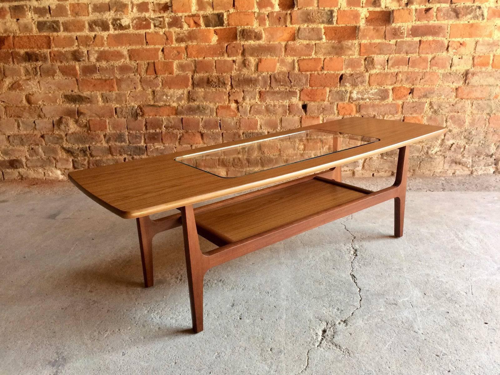 Fabulous Mid-Century Danish style Schreiber Aeroplane coffee table, circa 1970s, long rectangular top with glass inlay over magazine shelf below, raised on elegant tapering legs, makers mark to the underside, offered in super condition.