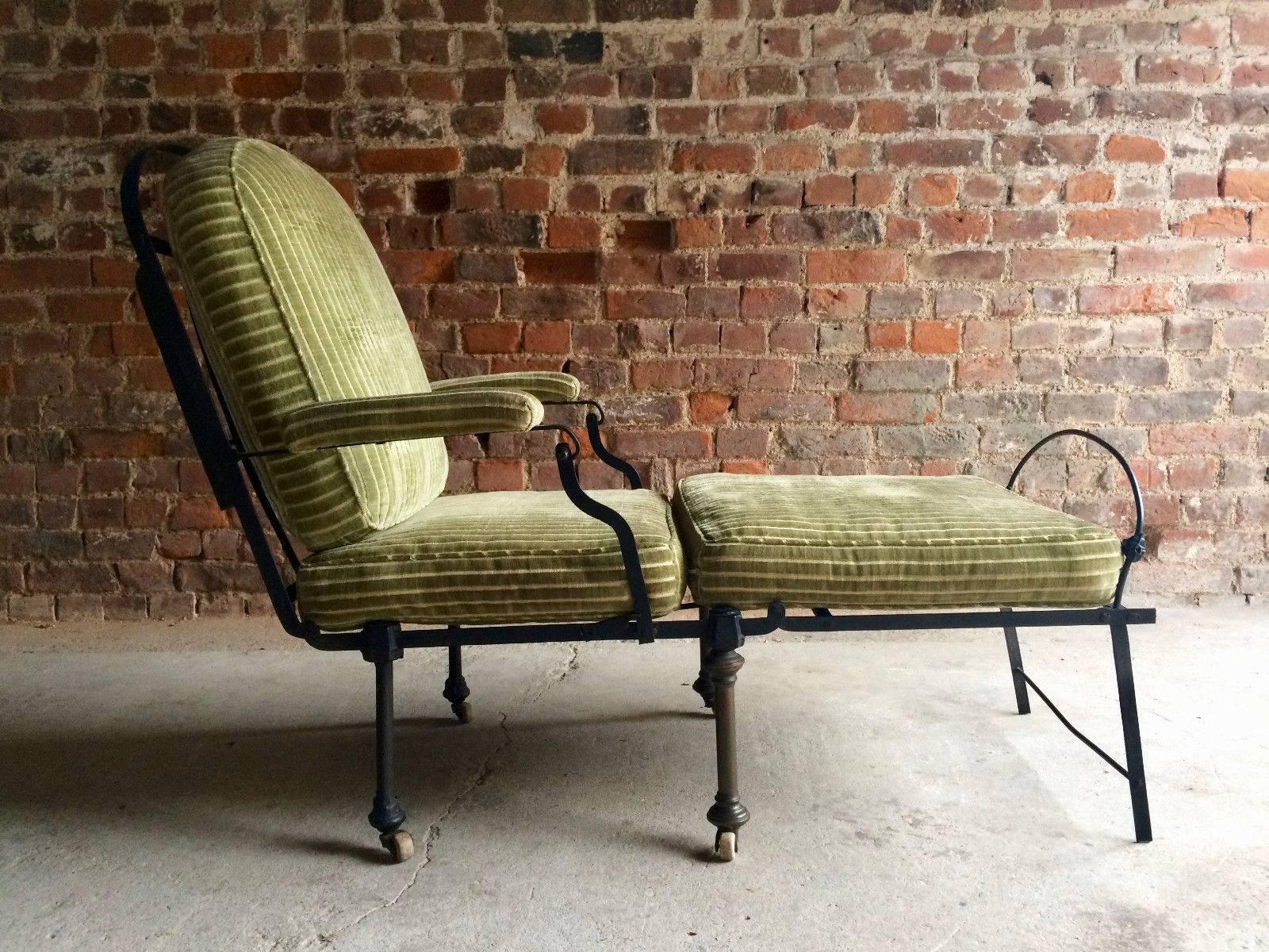 A fabulous 19th century and later, Campaign fold out daybed chair, black cast iron frame with green velvet upholstery, raised on casters, converts into a chair or bed, extremely stylish and very comfortable.
