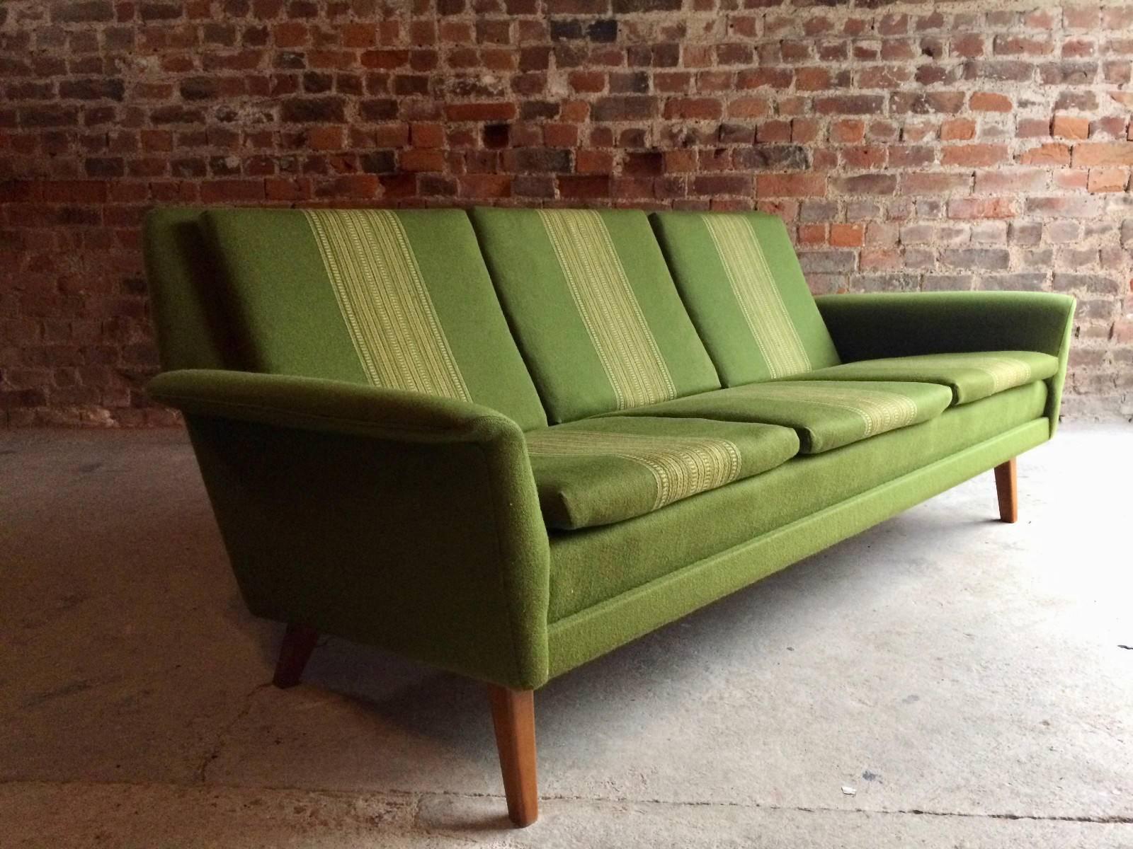Magnificent midcentury three-seat sofa designed by Folke Ohlsson and manufactured by Fritz Hansen in the 1960s for DUX. The sofa is upholstered in its original green striped fabric and raised on tapering teak legs.