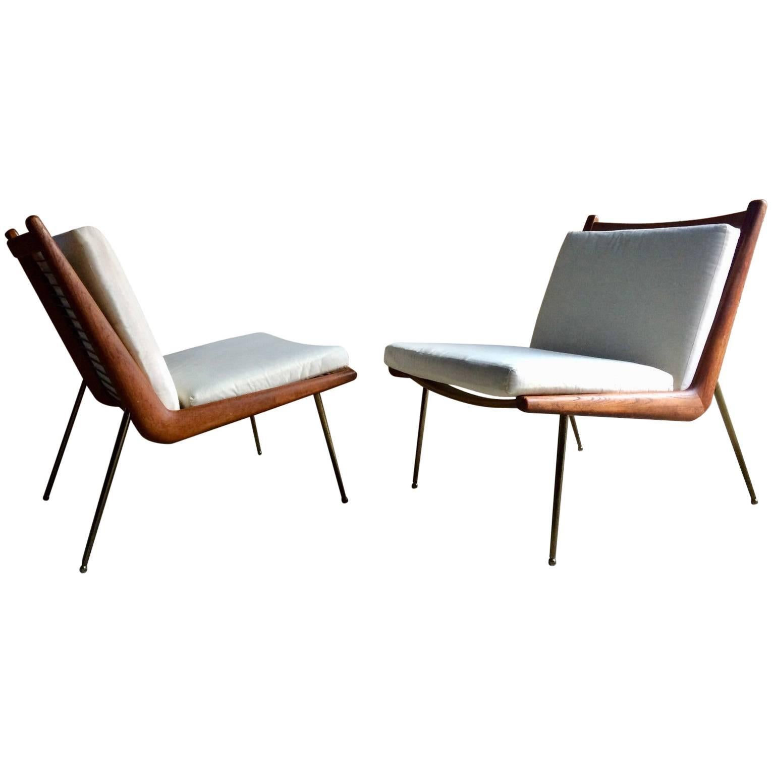 A pair of Boomerang chairs by Peter Hvidt and Orla Mølgaard Nielsen manufactured by France & Son, Denmark, the teak frames sit on brass-plated legs with sabots, the cushions are covered in a white calico material that will need to be cleaned or