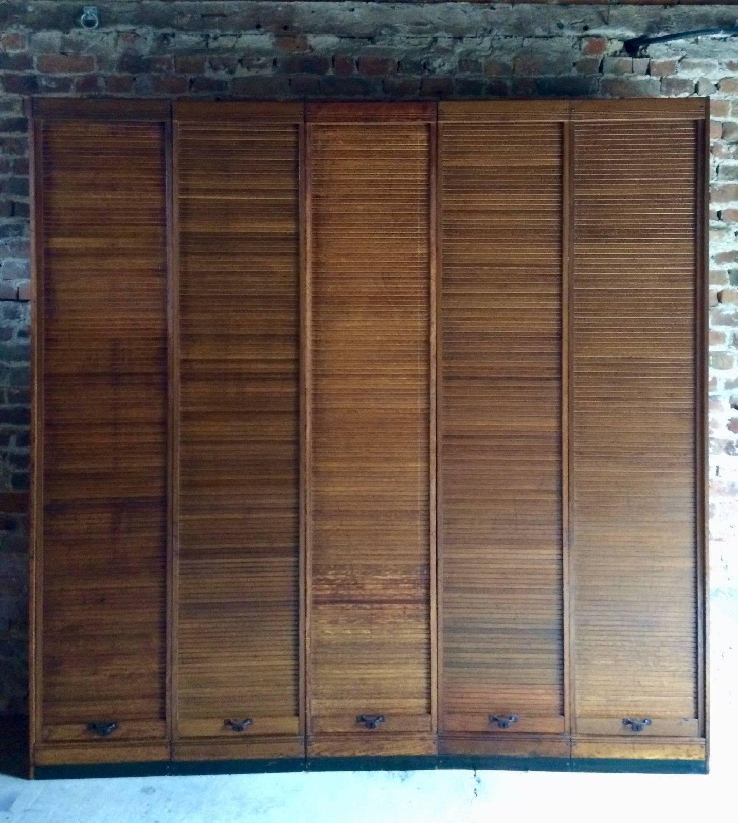 A beautiful midcentury haberdashery style five sectional Tambour fronted golden oak cabinet, the rectangular top over five drop down tambour shutter doors all with original pull handles concealing a quantity of shelves within, this item, seperates