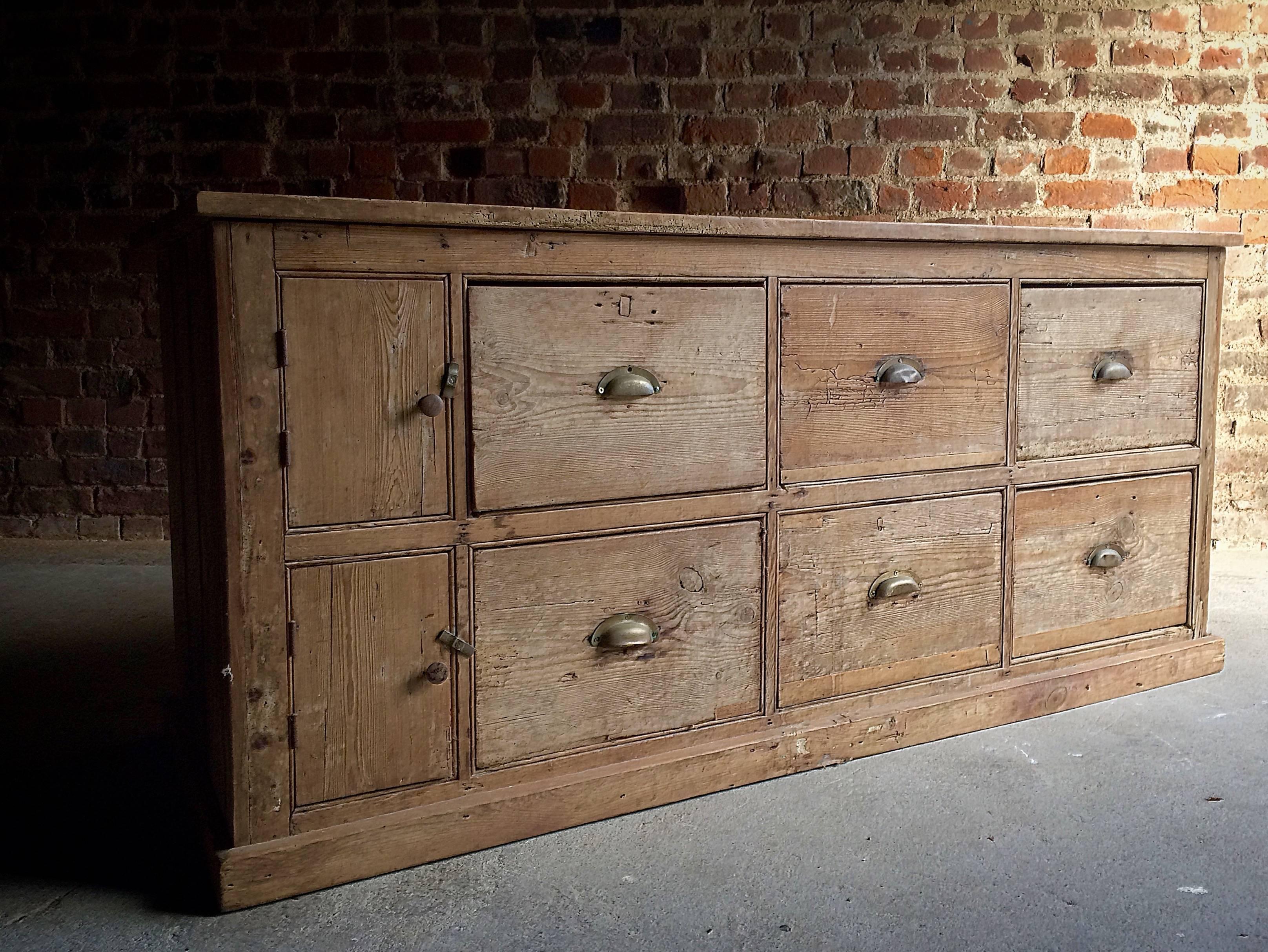A stunning antique 19th century Victorian Pine Haberdashery merchant shoppers chest , the chest having six drawers, three at the top and three below, all with brass cup handles. Also having two small cupboard doors to the left hand side, both with