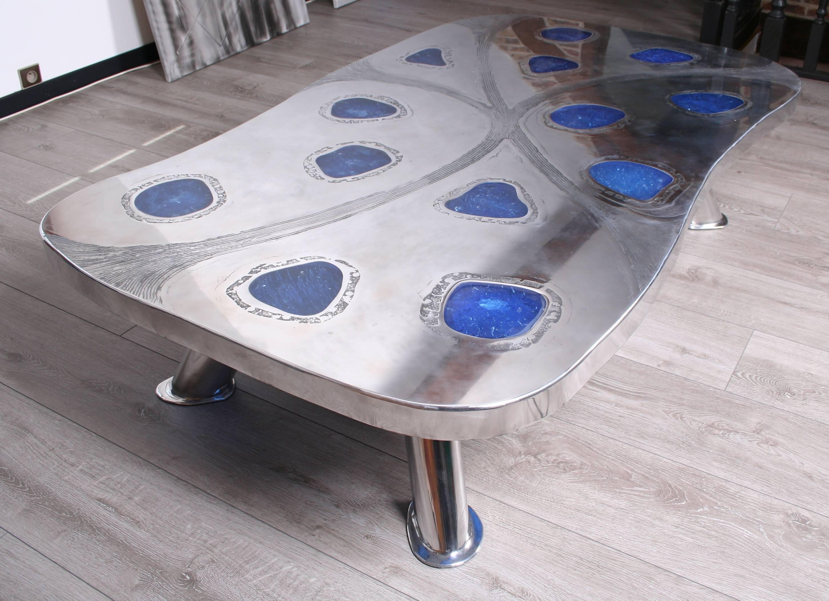 Coffee table in etched aluminium (Aquaforte) six oval legs with free shape ending. Free shape blue fractal resin measures 167 x 98 cm - 41 cm high. Limited edition. Designed and manufactured by Arriau.

Also available in etched brass and amber