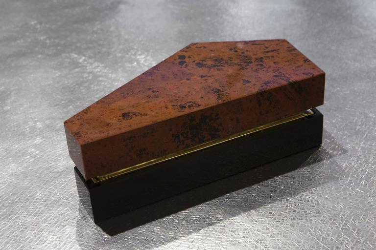 This beautiful decorative box is made of black obsidian, red obsidian and polished bronze. 

Cortina’s designs are inspired by numerous historical and creative forces, from the ancient Aztecs to the 20th Century Mexican masters Luis Barragan and