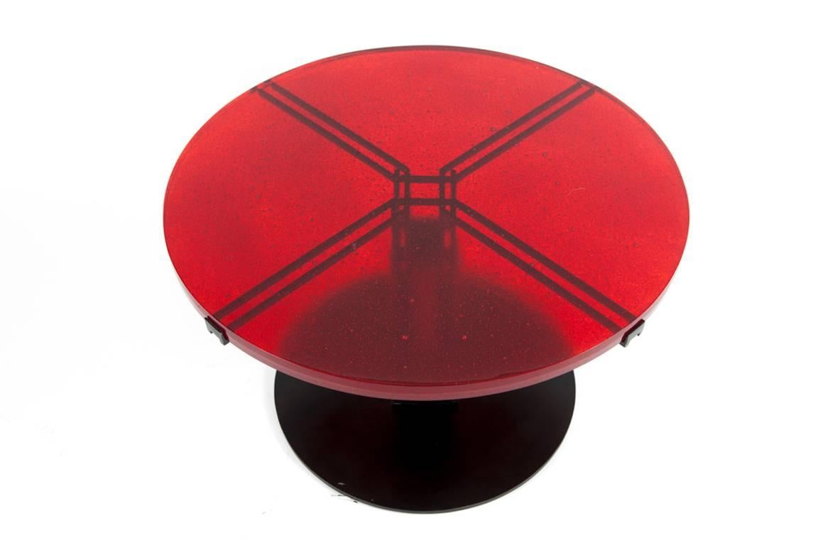 Christophe Côme's beautiful table from 2014 is made of iron, red enamel and red glass. 

Côme lives and works in Paris, France. Raised in an artistic family, his uncle is a renowned ceramicist and his sister an acclaimed illustrator. Côme