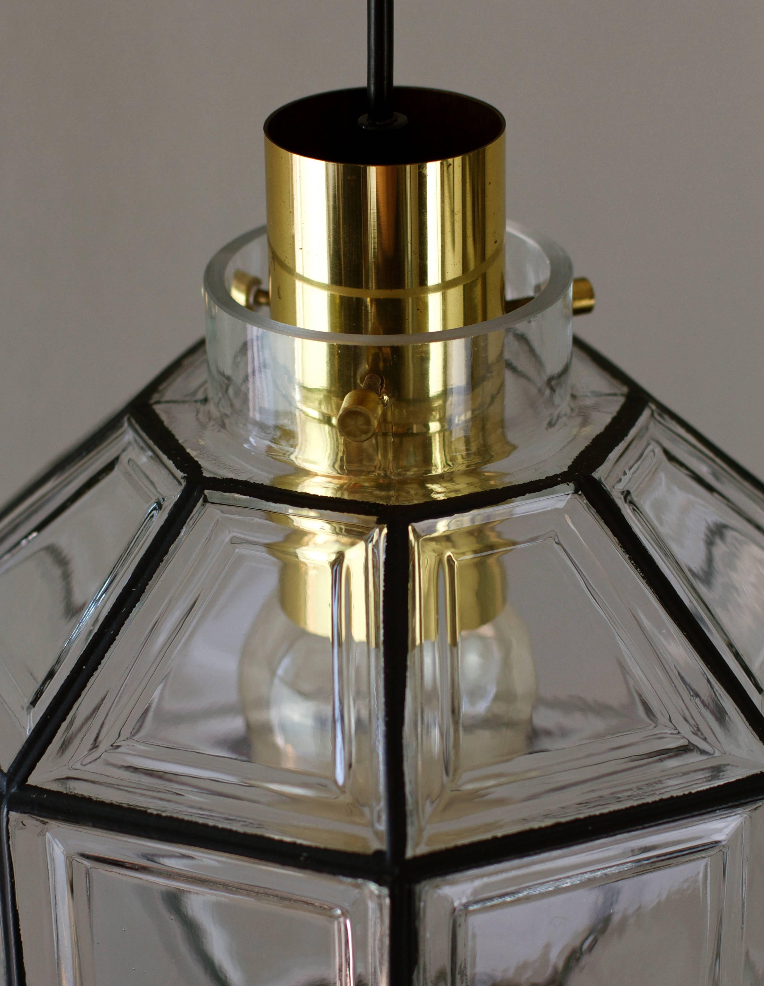 Beautifully designed and crafted octagonally shaped and multi-faceted clear glass & brass Mid-Century pendant light. These large minimalistic, Contemporary Art Deco and Lantern style lights were manufactured by Limburg Glashütte, Germany, circa