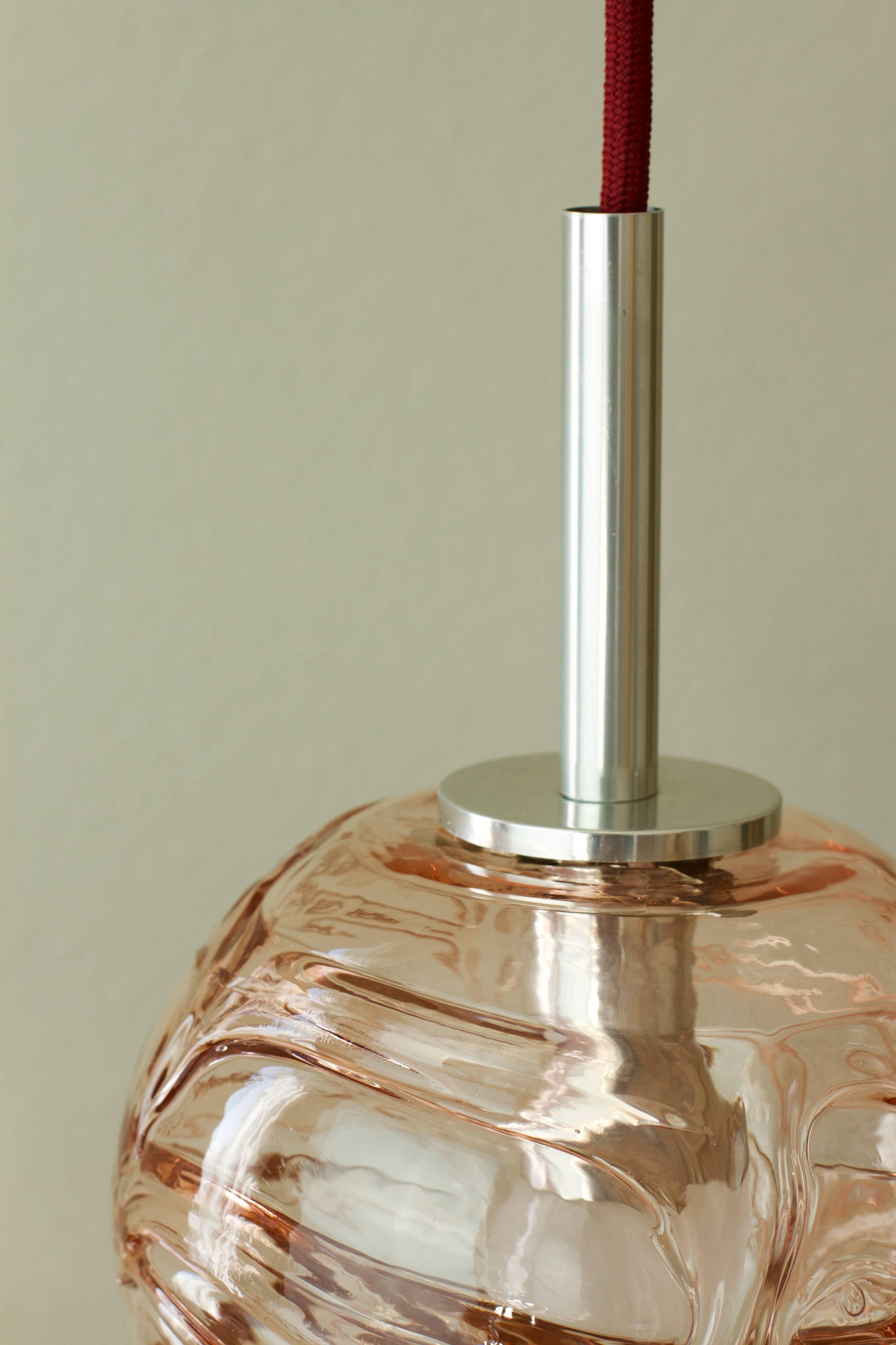 This beautiful little rose pink tinted Mid-Century glass pendant light by Doria Leuchten, Germany, is very minimal / minimalist. Made in the later half of the 1960s, this gorgeous little pendent features wonderfully made, mouth blown Murano glass