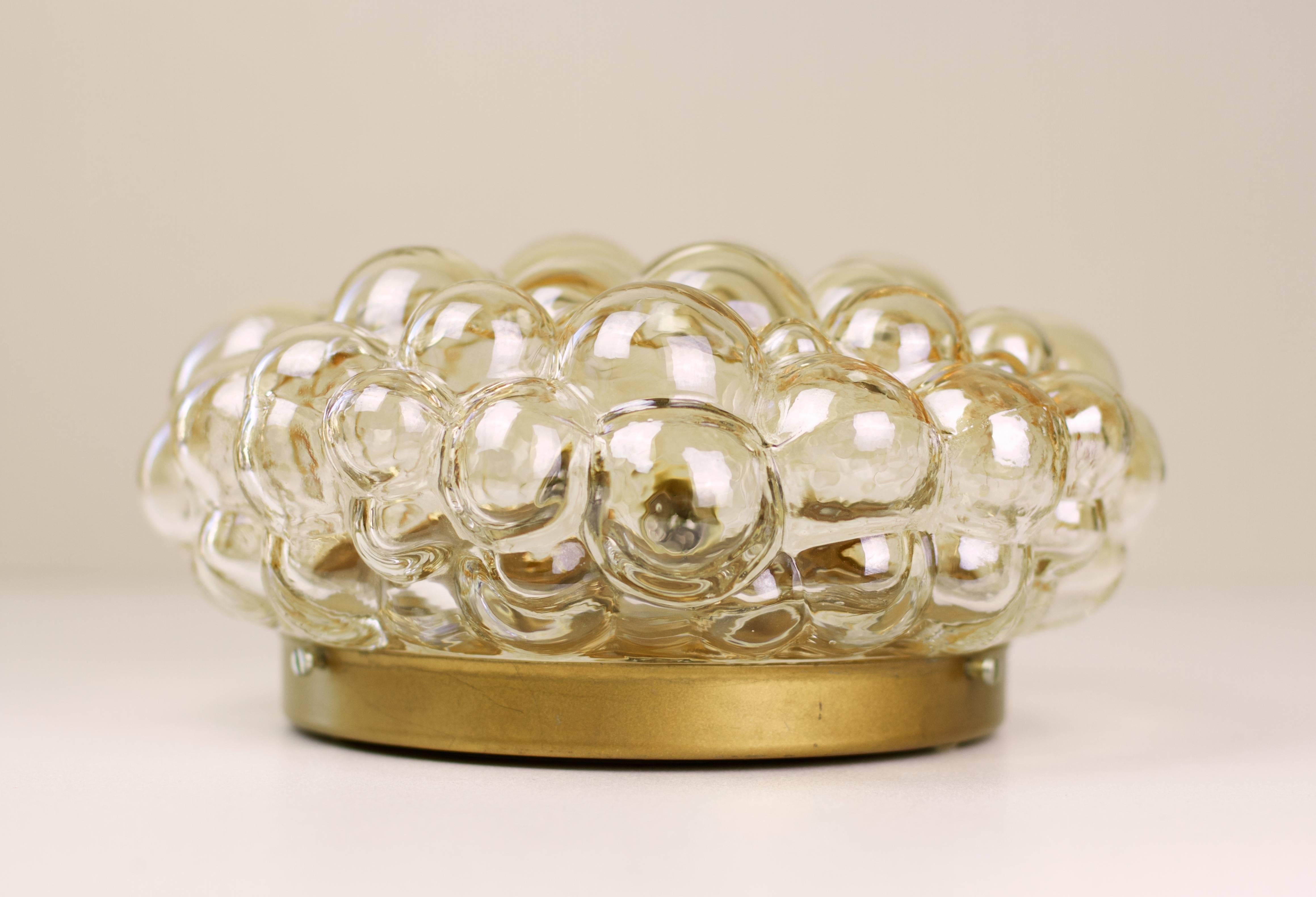 One of a beautiful pair of Mid-Century bubble glass wall or ceiling flush mount wall or ceiling lights designed by Helena Tynell for Glashütte Limburg, Germany, circa 1960. The glass has a subtle amber / champagne color (colour) and sits within a