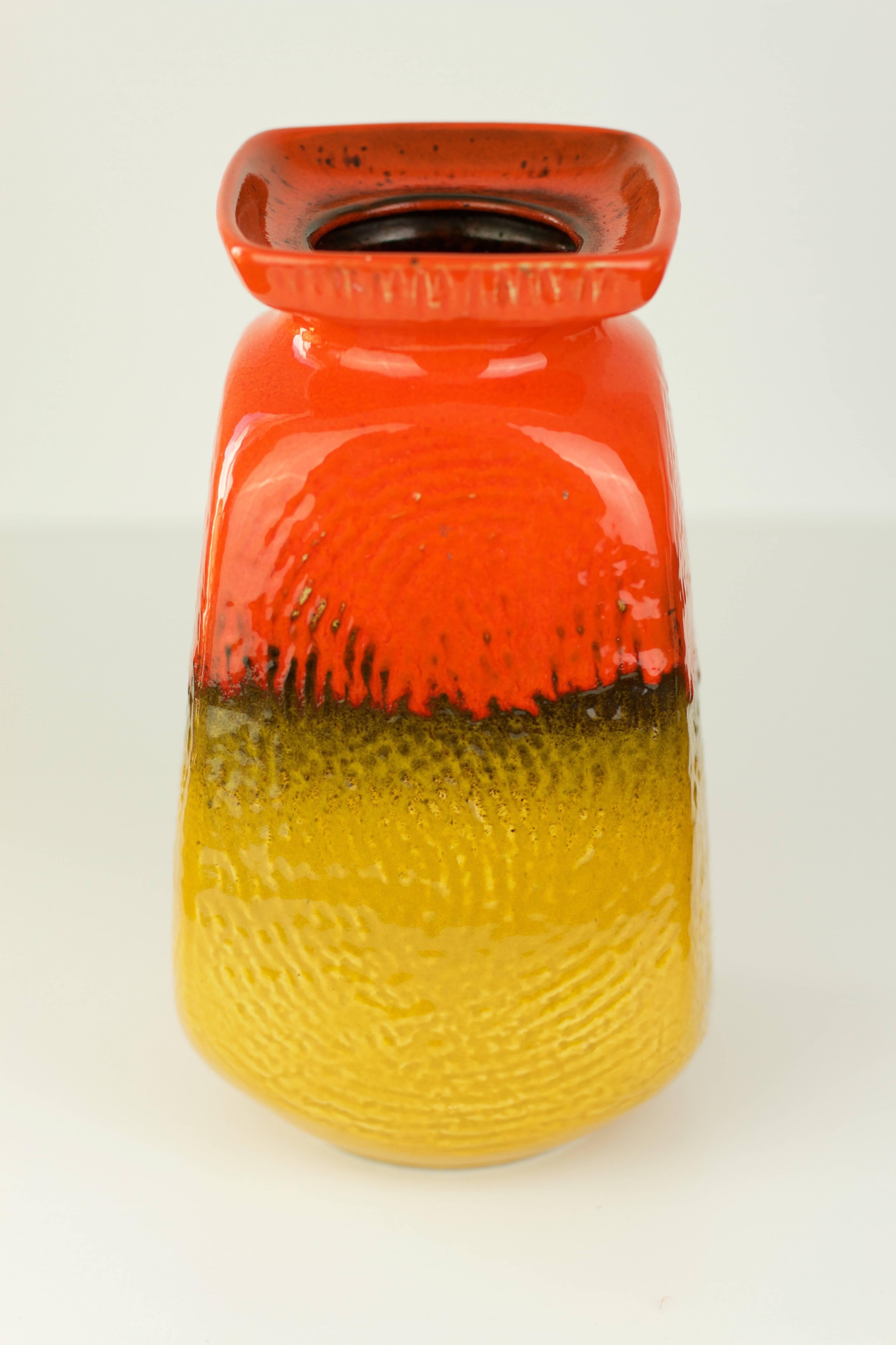 A beautiful vase in striking bright orange and mustard yellow with an embossed pattern resembling a fingerprint - shape number 3151124 - produced by Jasba Pottery in the mid-1970s.

This vase makes a fantastic, striking statement when displayed on