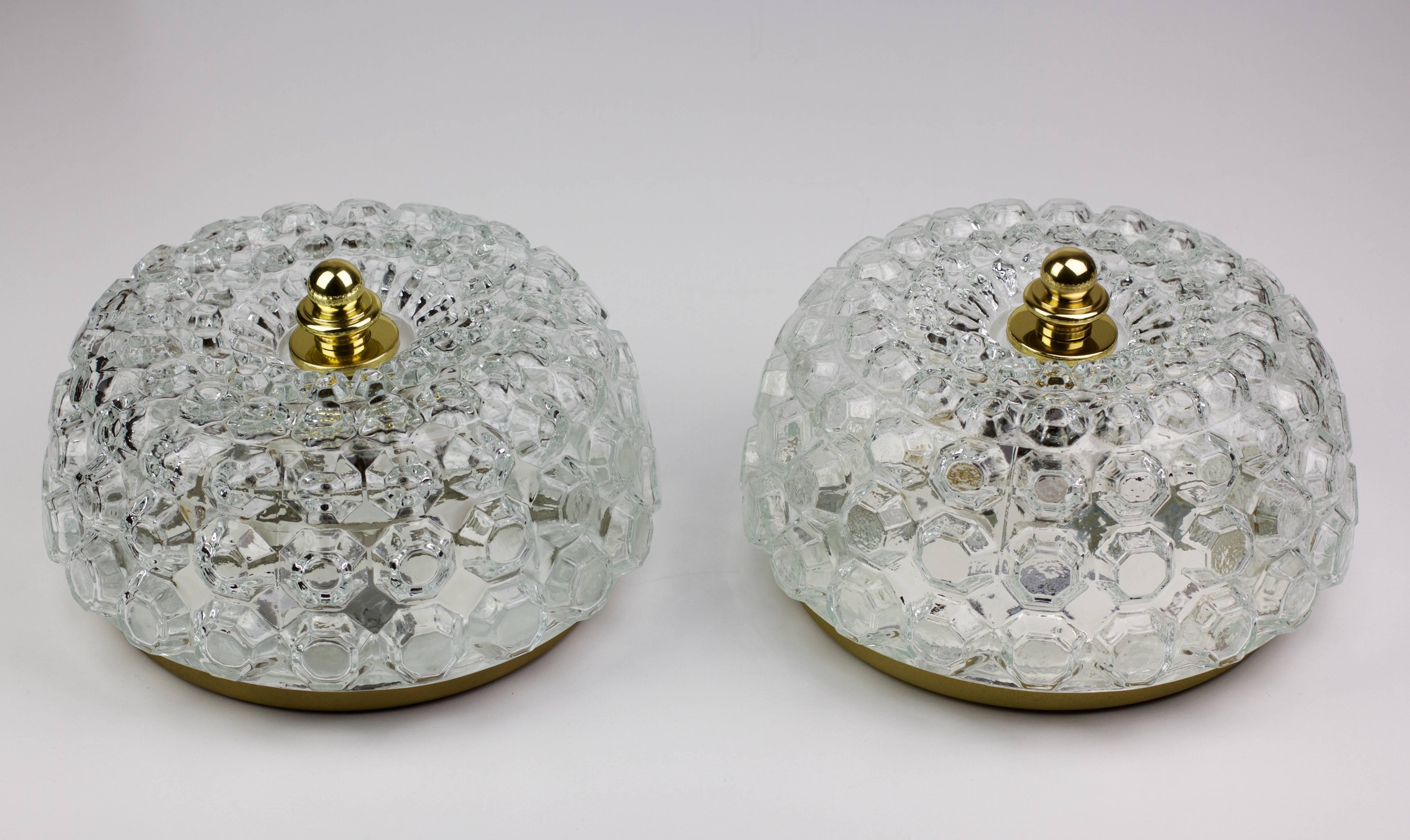 Elegant Mid-Century clear glass flush mount light fixtures by Helena Tynell for Glashütte Limburg, circa 1968. The honeycomb patterned design casts a stunning light through the crystal clear glass - whether wall or ceiling mounted the add a touch of