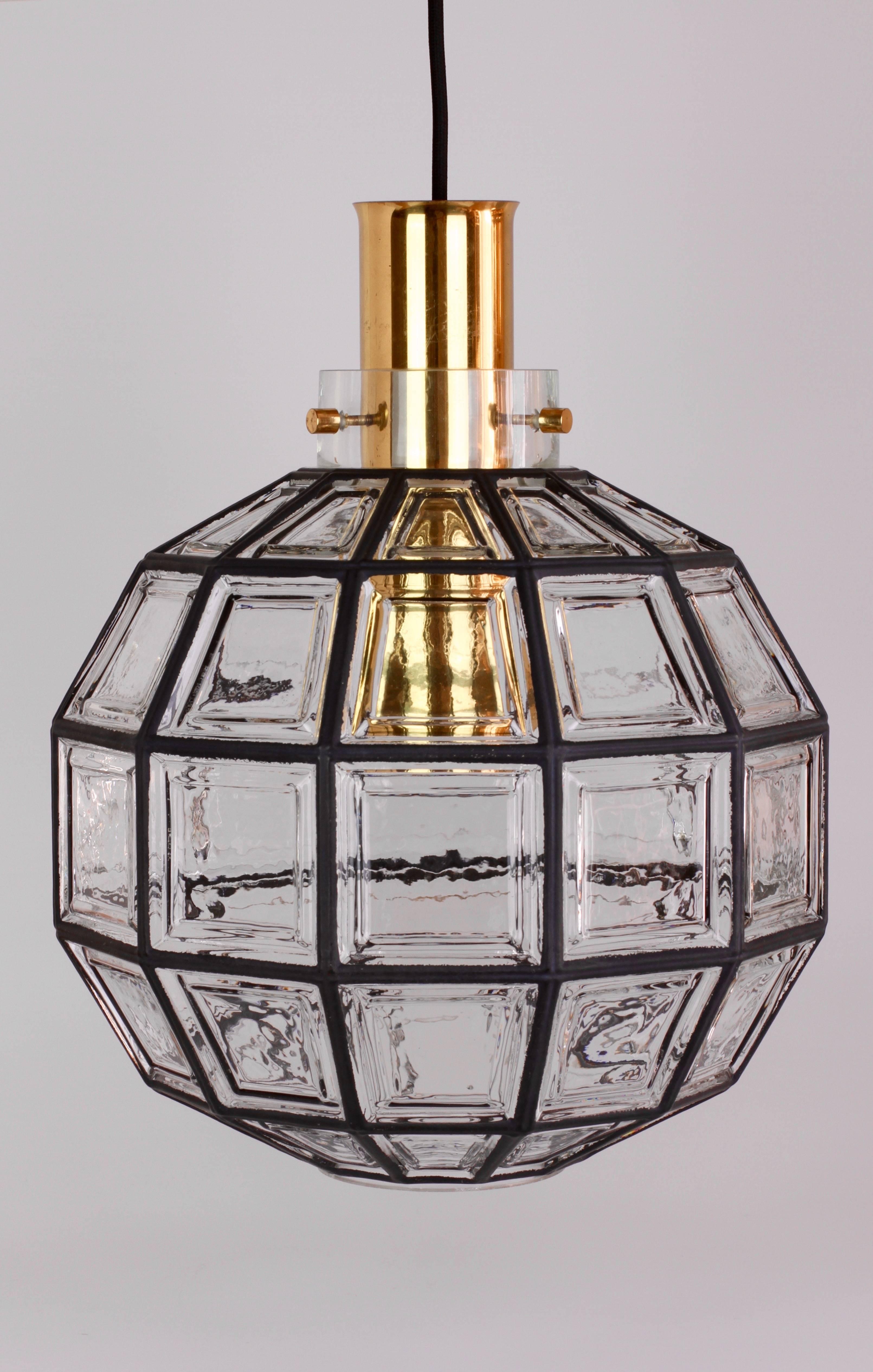 Beautifully designed and crafted, octagonal shaped and multi-faceted clear glass and brass midcentury pendant light. These large minimalistic, Contemporary Art Deco lantern style lights were manufactured by Glashütte Limburg, Germany, circa