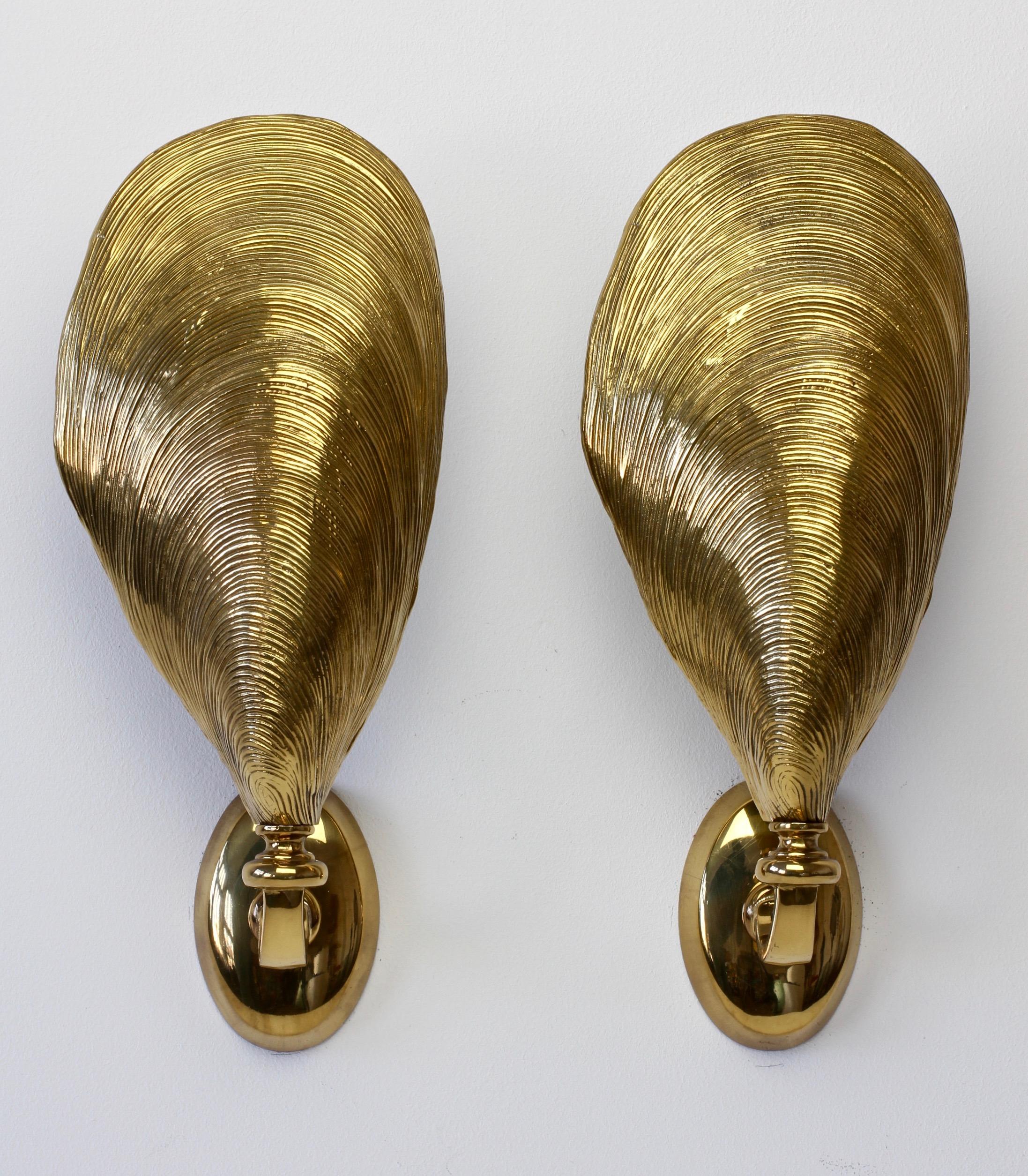 An absolutely stunning pair of midcentury wall-mounted sconces attributed to Maison Jansen, France, circa 1970s. In the shape of mussel shells and made of cast bronze, these are not dissimilar to lights made by Maison Charles - however, we believe