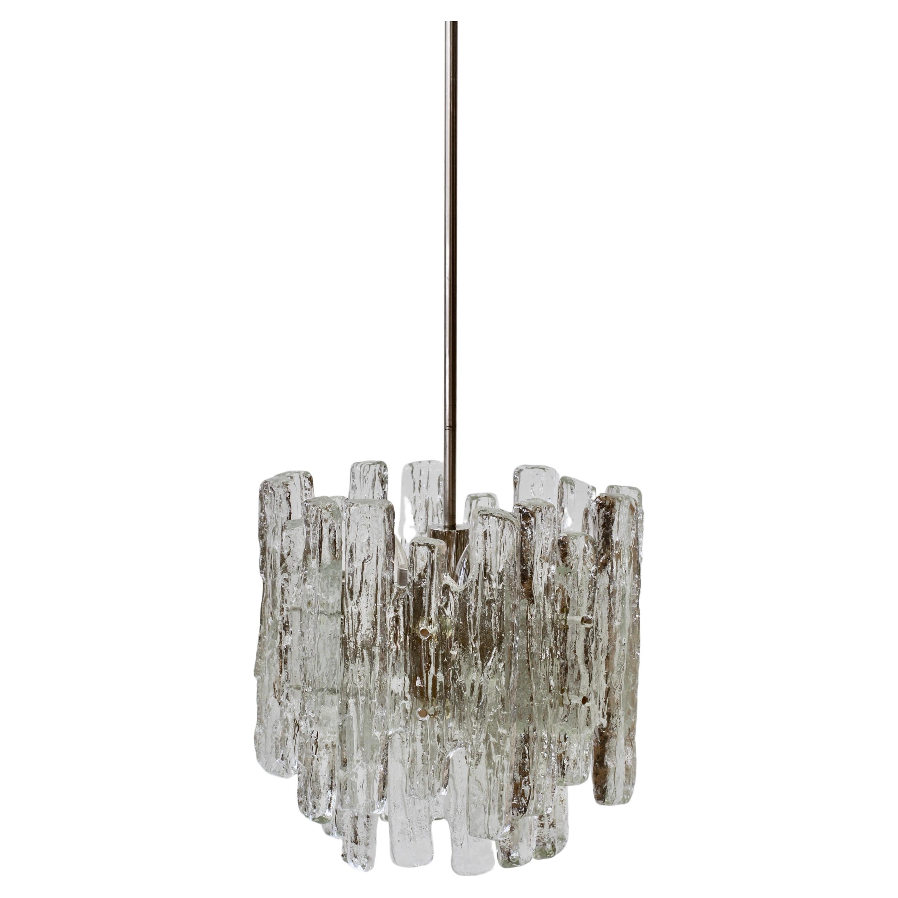 Set of three vintage midcentury Austrian made textured clear ice glass ceiling pendant lights / lamps or chandeliers by Kalmar, circa 1974. Featuring twelve hanging glass elements (six large & six small) resembling melting ice crystals suspended