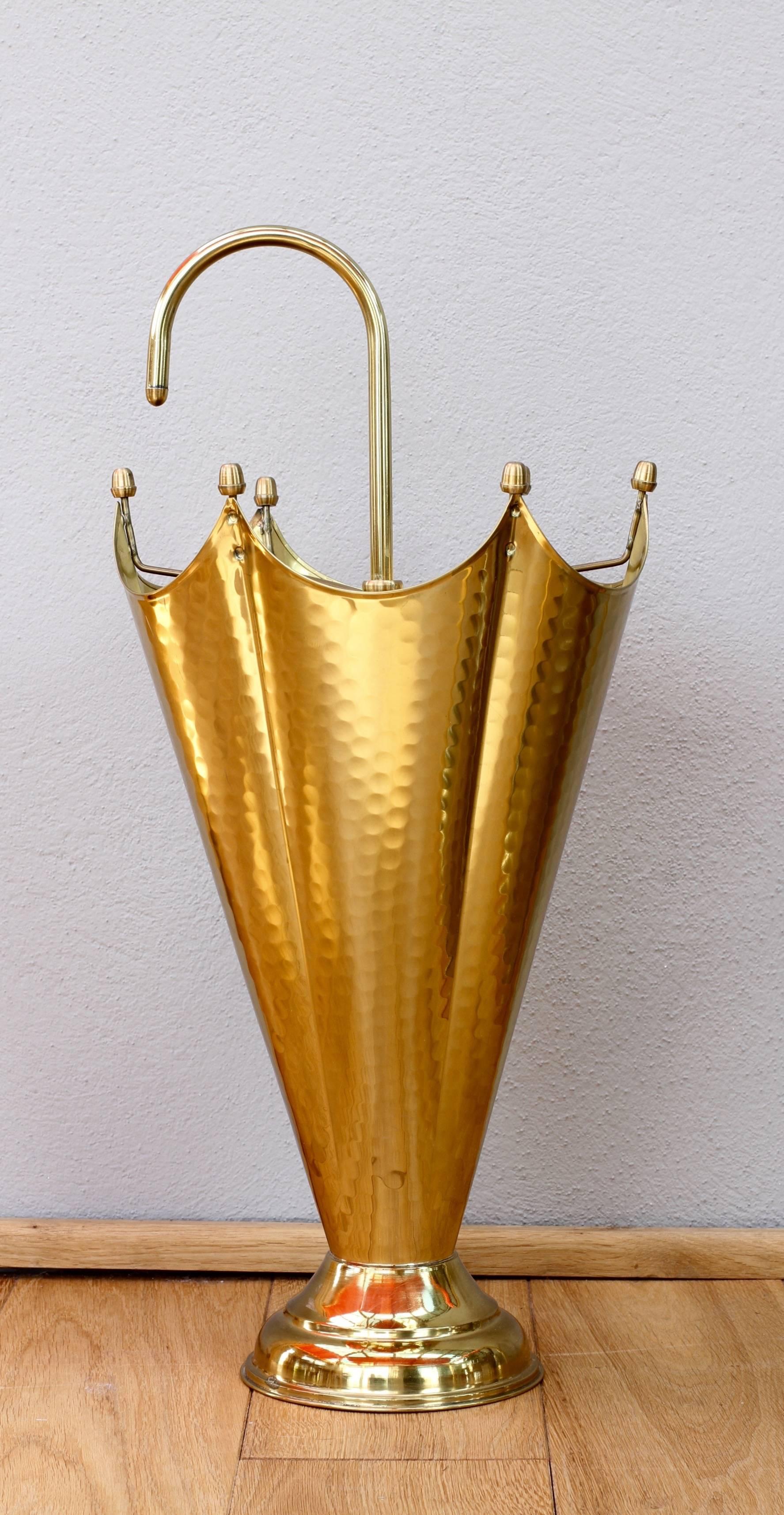 This lovely Mid-Century piece is very likely Italian or possibly French and dates between 1940-1950. Made of brass with a high copper content it shines like gold in the sun capturing and highlighting the hammered metal detailing. 

This Umbrella