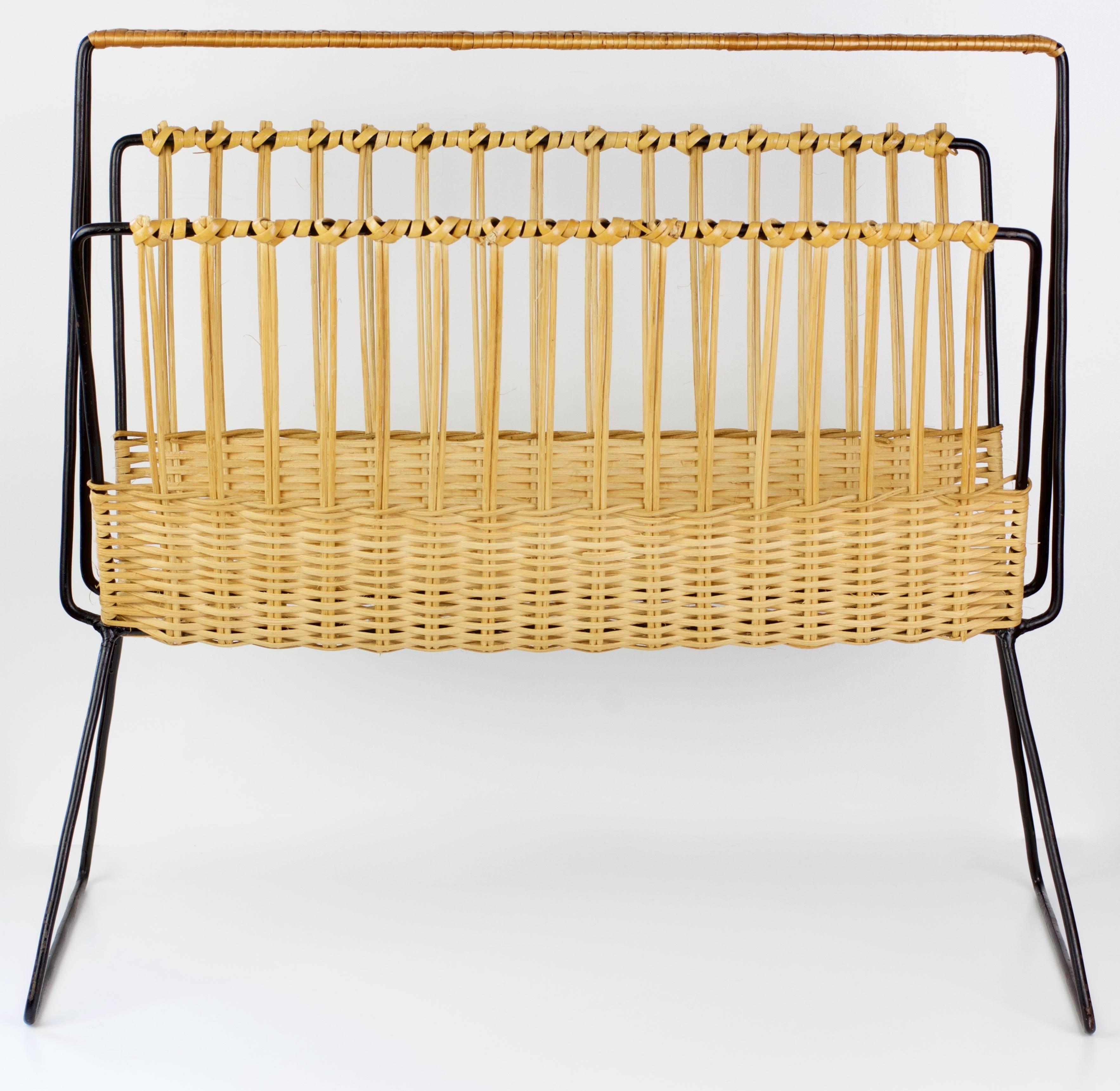 This large magazine stand / holder was made in Holland by Dutch Company Rohe Noordwolde, circa 1958. The blonde woven wicker / rattan wraps around the black enameled steel wire frame creating, what is, a wonderfully minimal, modernist piece of