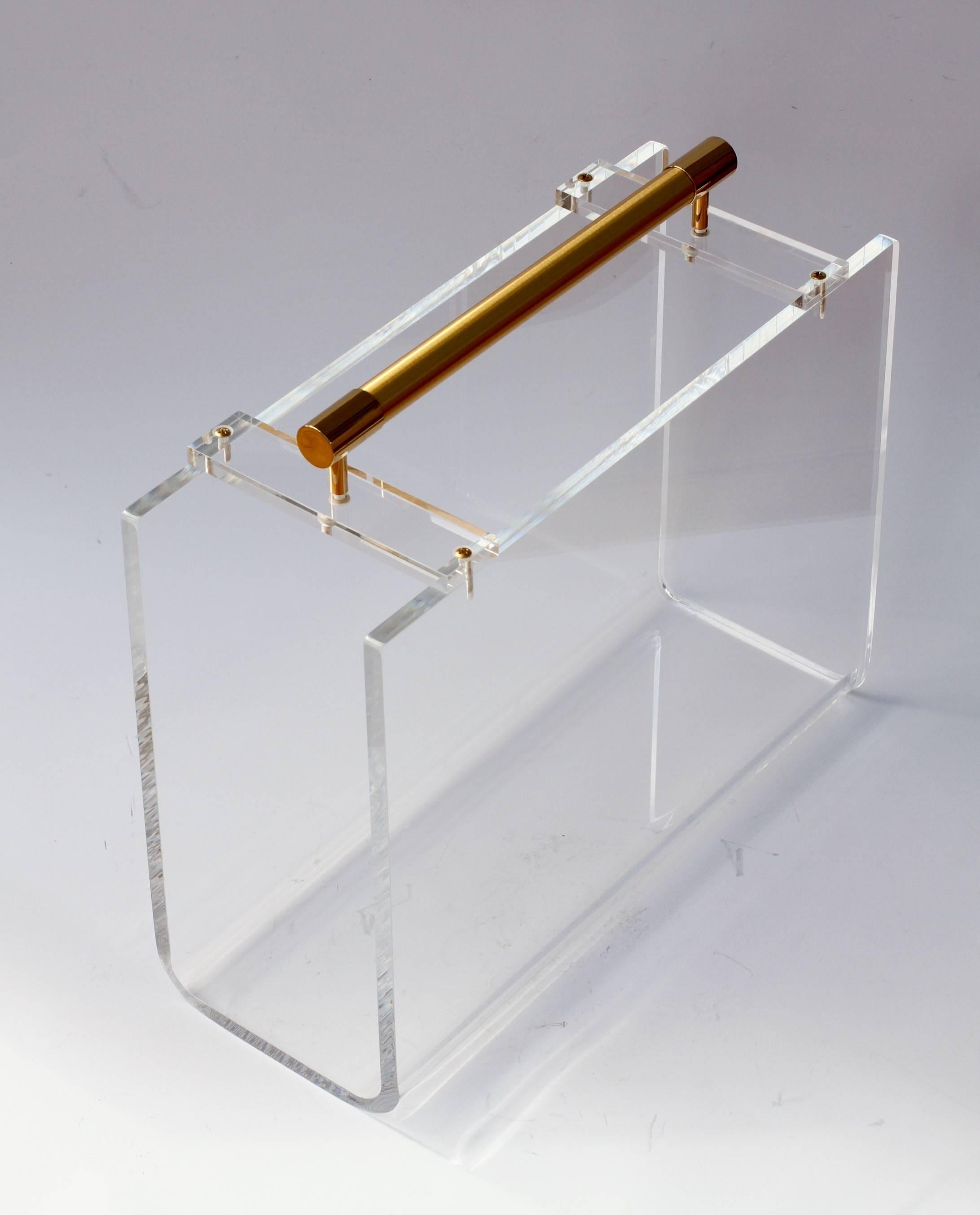 This beautiful Karl Springer / Carles Hollis Jones style magazine / newspaper / book rack, holder or stand is made from a very high quality acrylic resin (Lucite is a brand - the material is Acrylic) and features a large, gold plated carrying handle