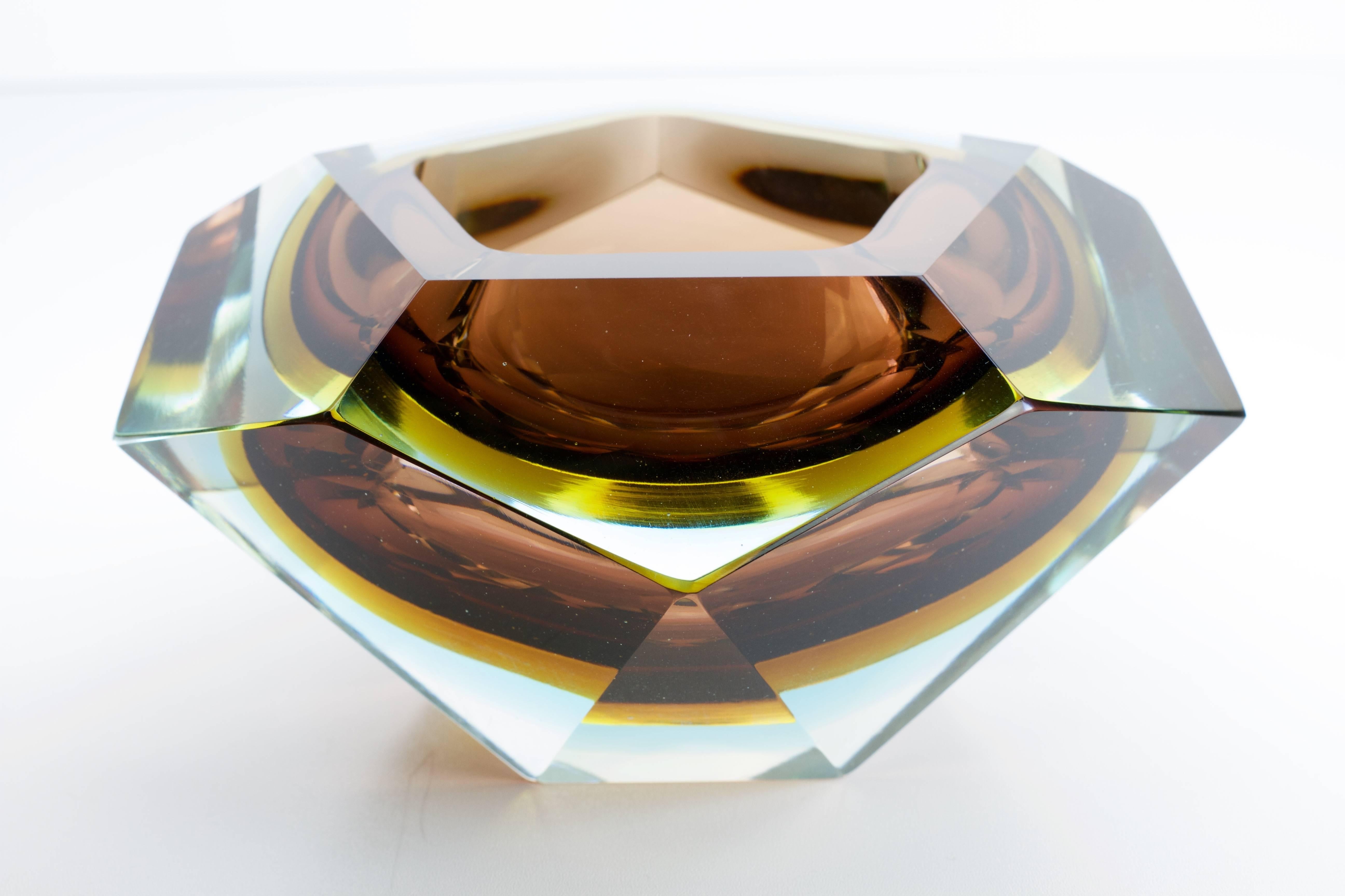 This large Italian Mid-Century Modern Murano glass bowl was produced by Mandruzzato, circa 1960. Exceptional in every way, commanding you to admire its stunning design and masterful production. Faceted on five sides and utilizing the Sommerso