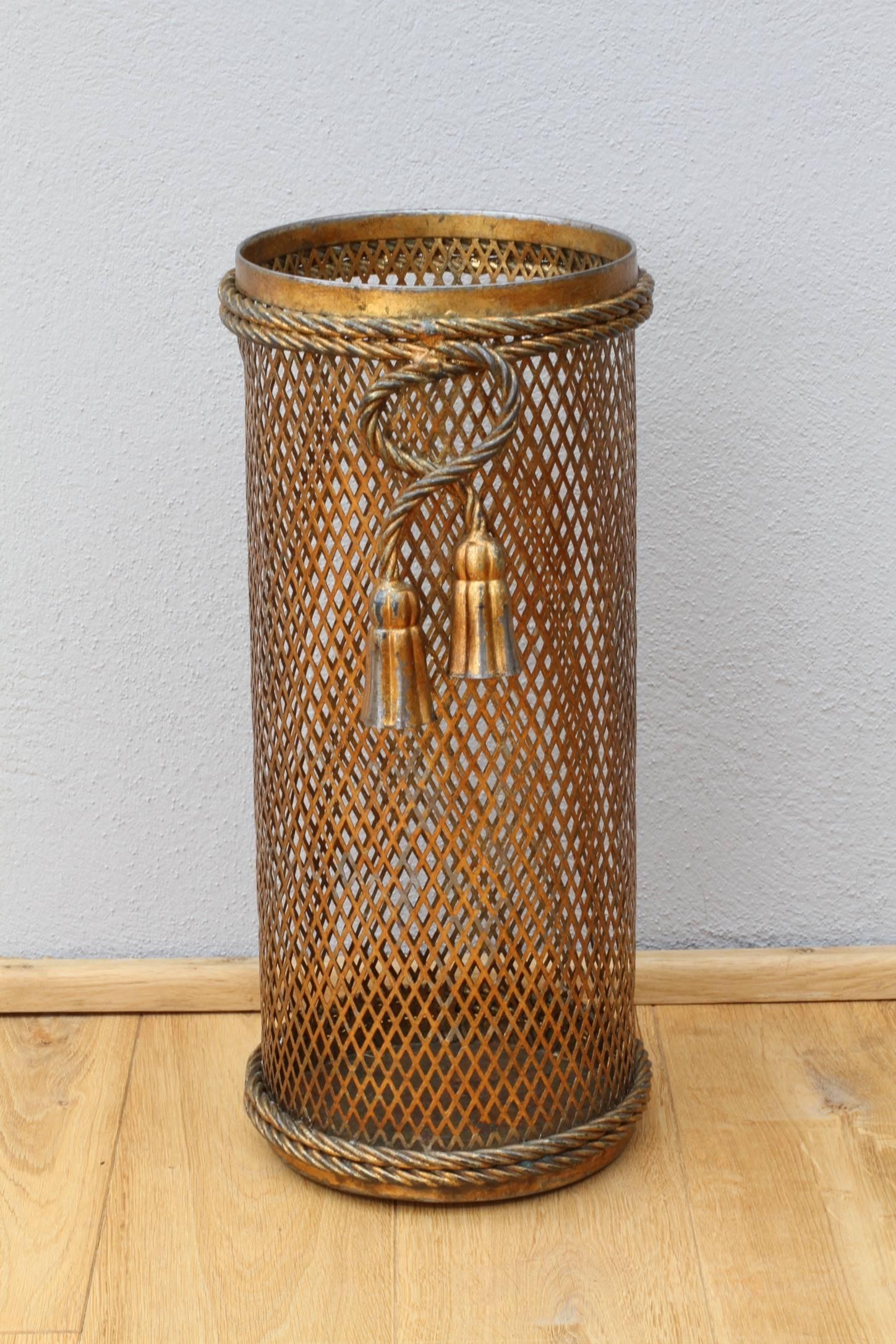 Stunning Mid-Century gold / gilt / gilded Hollywood Regency style umbrella stand / holder made in Florence, Italy, circa 1950 by Li Puma Firenze. The perforated lattice patterned metalwork with bent rope and tassel details finishes the piece