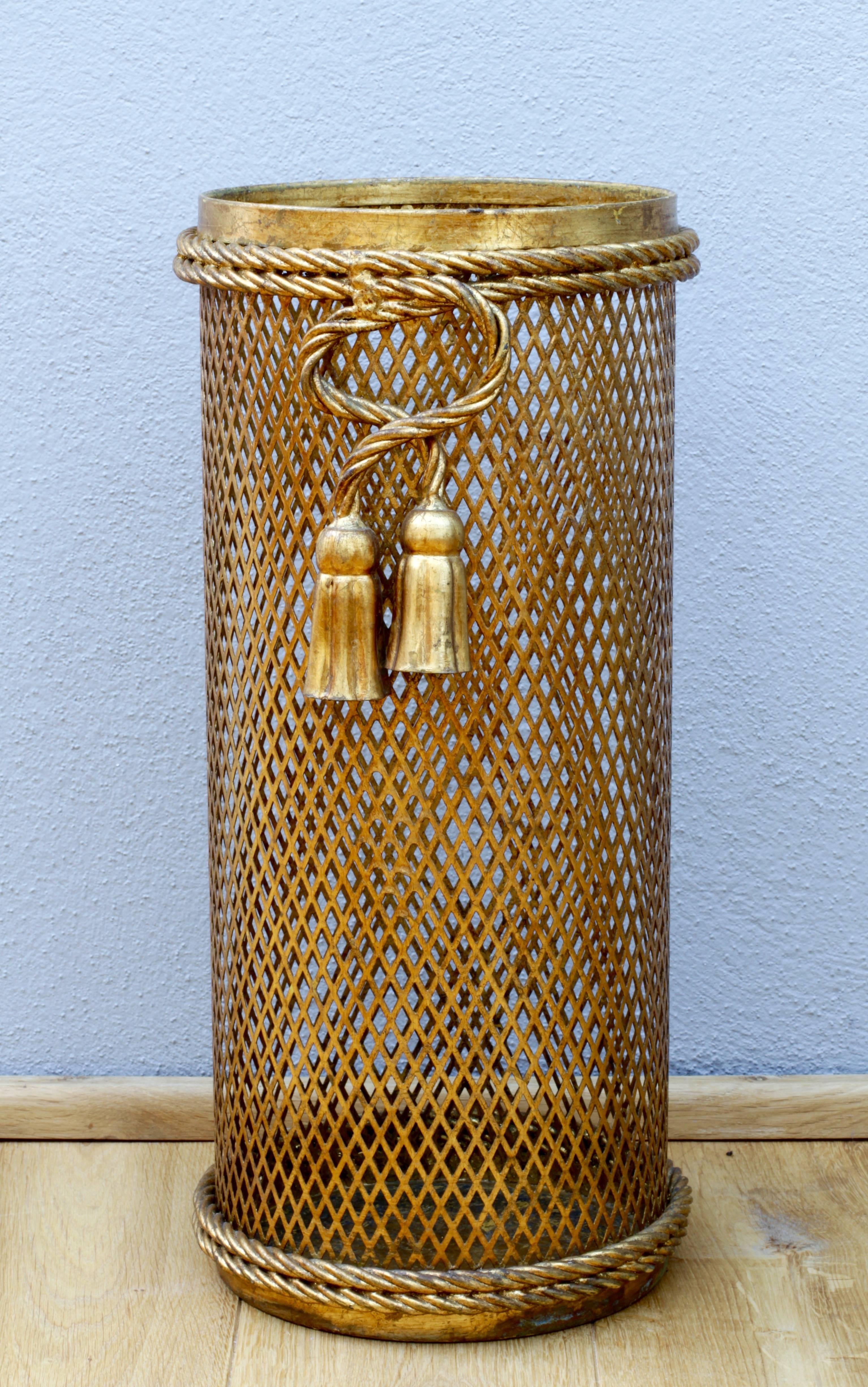 Stunning Mid-Century gold/gilt/gilded Hollywood Regency style umbrella stand or holder made in Florence, Italy, circa 1950 by Li Puma Firenze. The perforated lattice patterned metalwork with bent rope and tassel details finish the piece perfectly.