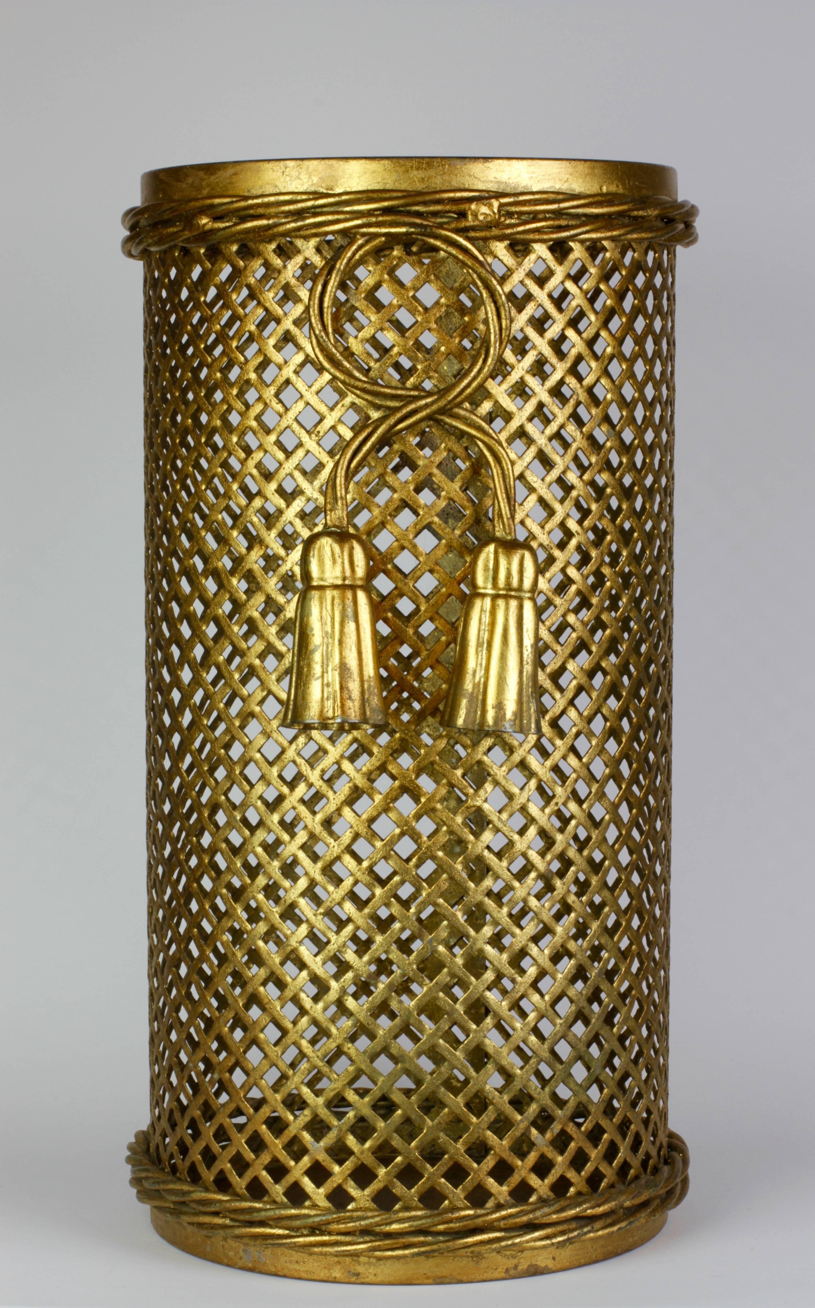 Stunning Mid-Century gold, gilt or gilded Hollywood Regency style umbrella stand or holder made in Florence, Italy, circa 1950 by Li Puma Firenze. The perforated lattice patterned metalwork with bent rope and tassel details finishes the piece