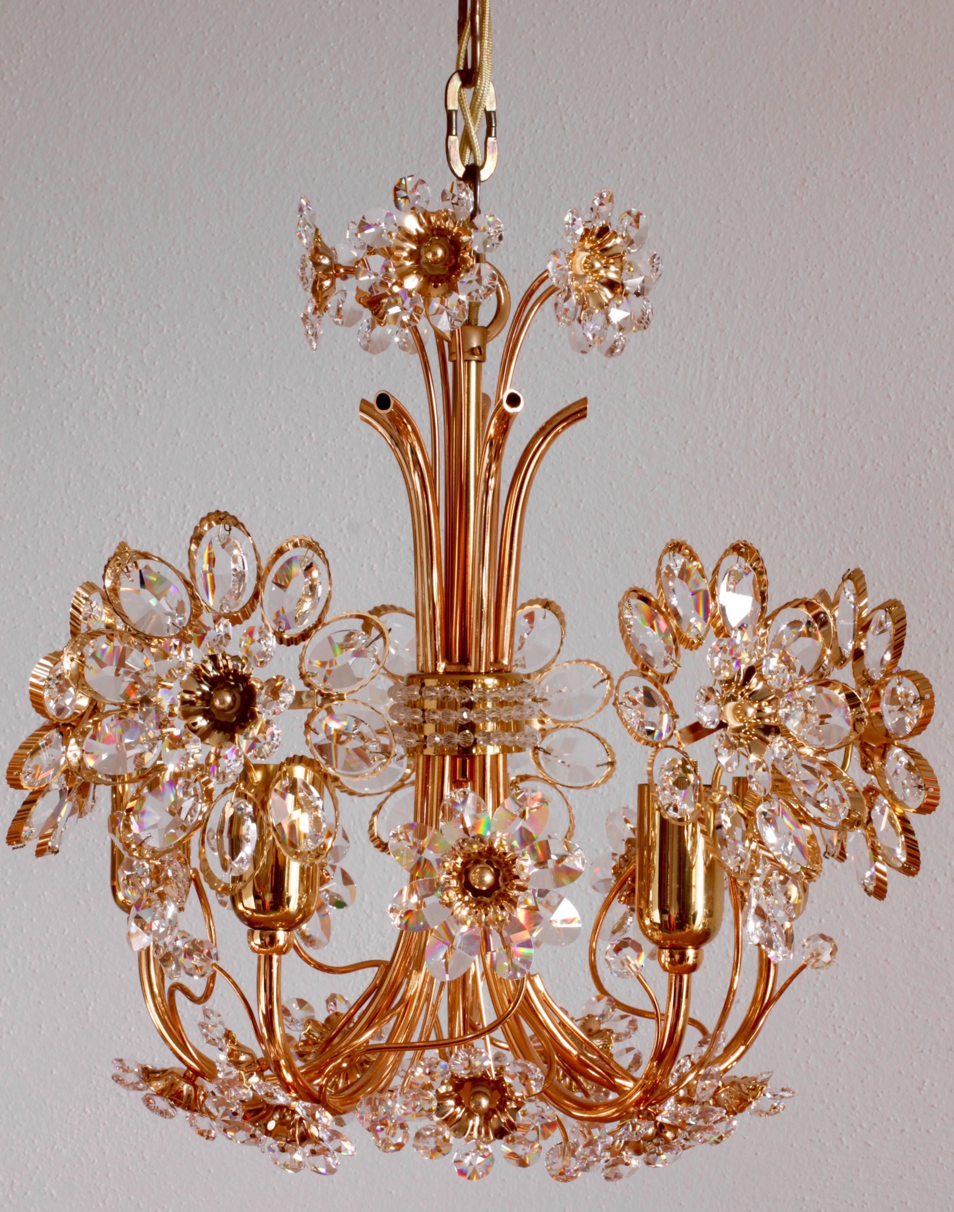 An absolutely stunning Mid-Century German gilt brass and cut crystal chandelier by Palwa, circa 1965-1975. Perfect for the Hollywood Regency style, there is no better combination than gold and crystal for the opulent, decadent and luxurious look of