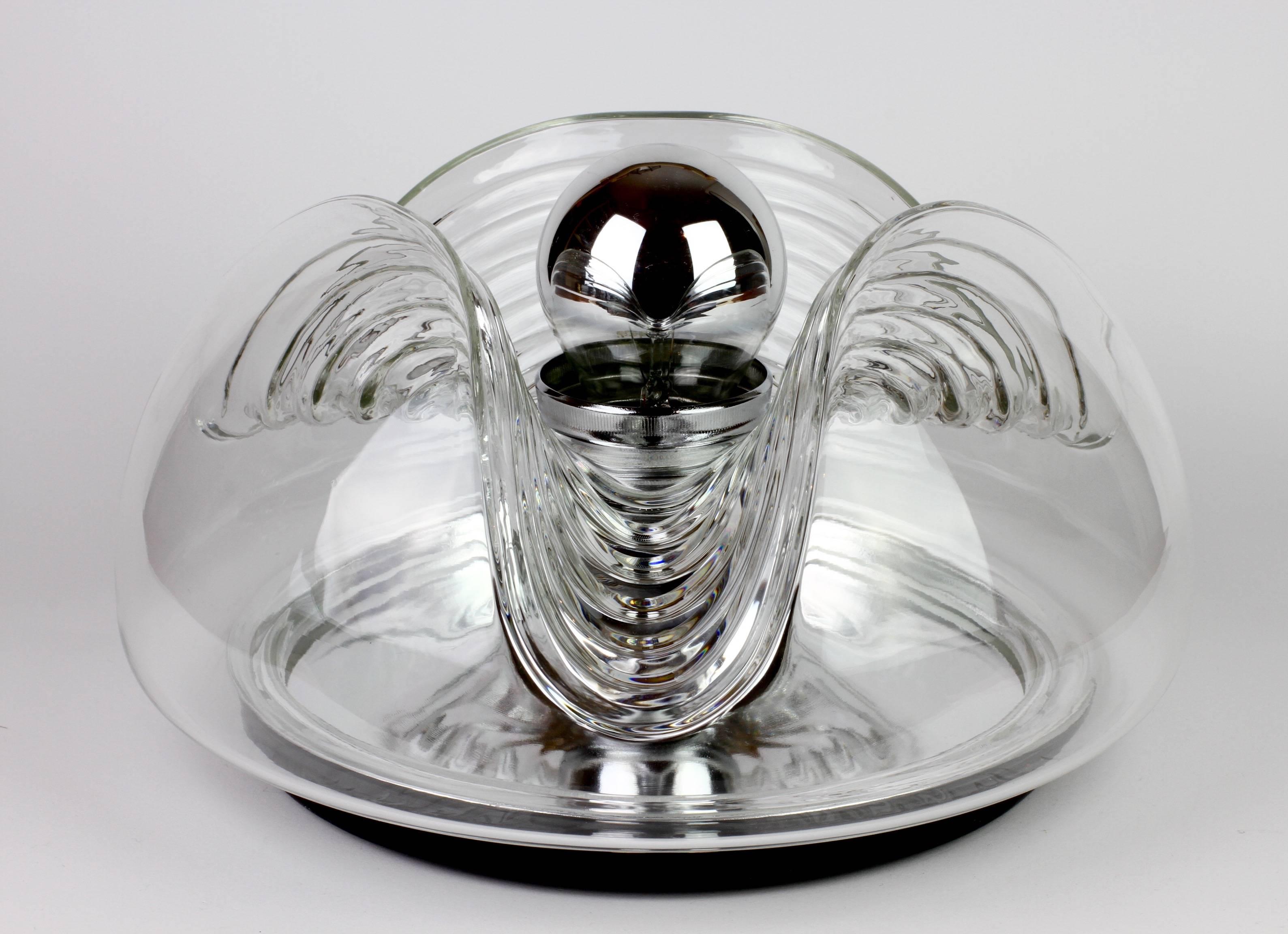 Mid-Century flush mount wall lights or sconces available singularly, as pairs or a set of four originally designed by Koch & Lowy for Peill & Putzler in the 1970s. This is an absolutely Classic piece of German design, featuring a clear glass globe