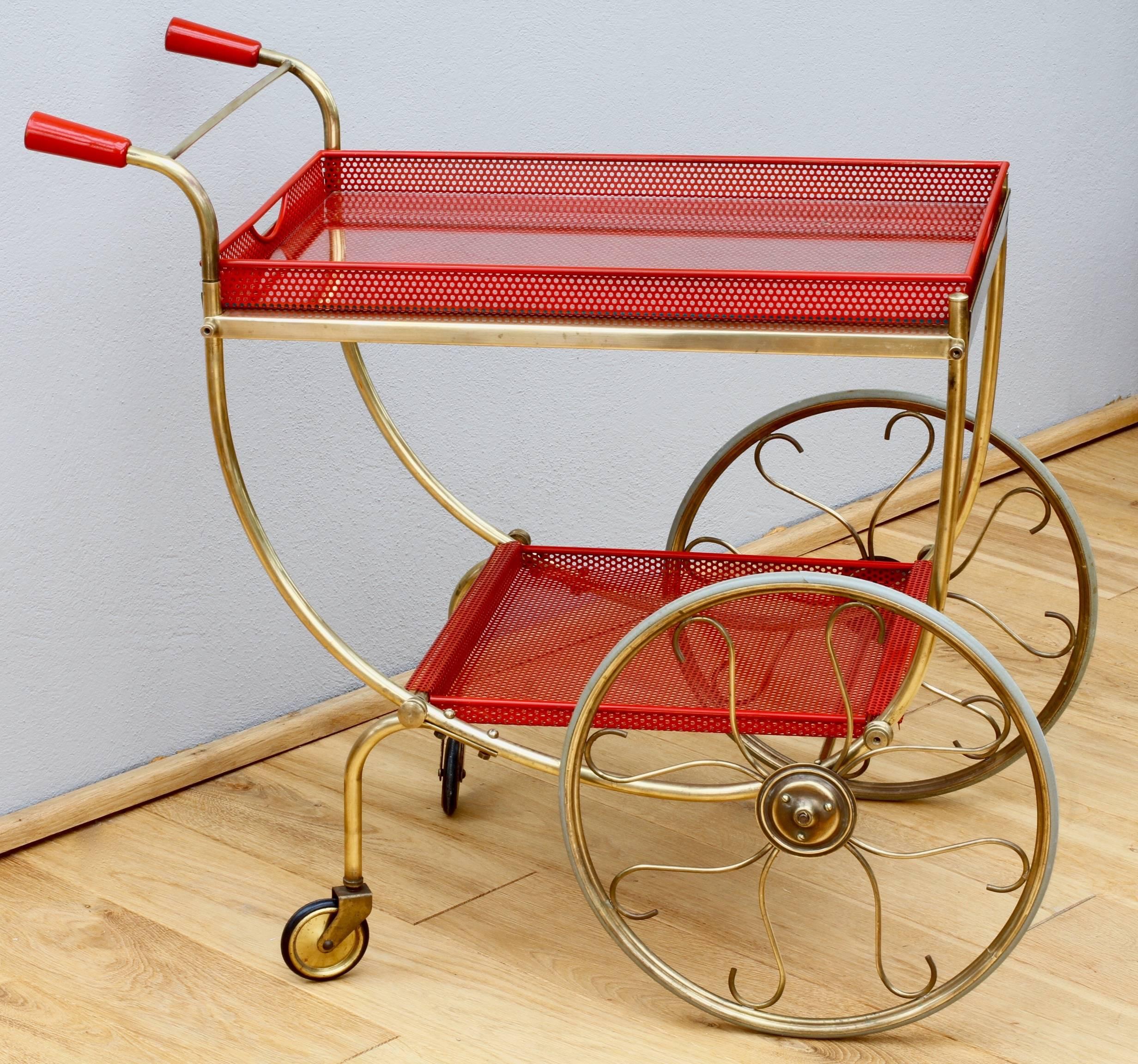 An absolutely wonderful and stunning mid century modern bar cart / drinks trolley by Swedish design company Svensk Tenn circa 1950s. Made of tubular brass and red painted perforated metal - the trolley is very much in the style of the legendary