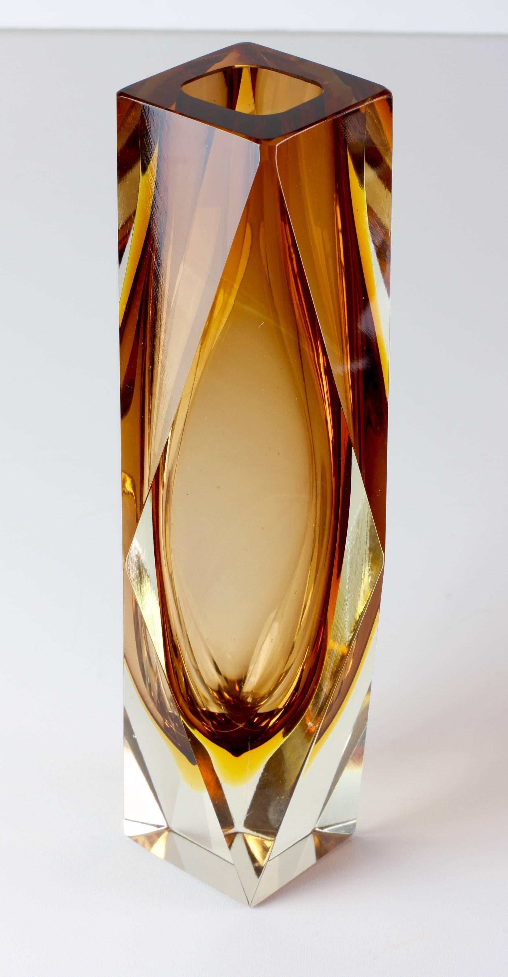 This beautiful Italian Mid-Century Modern Murano glass vase in the Style of Mandruzzato. Exceptional in every way, commanding you to admire its stunning design and masterful production. Faceted on four sides and utilizing the Sommerso technique over