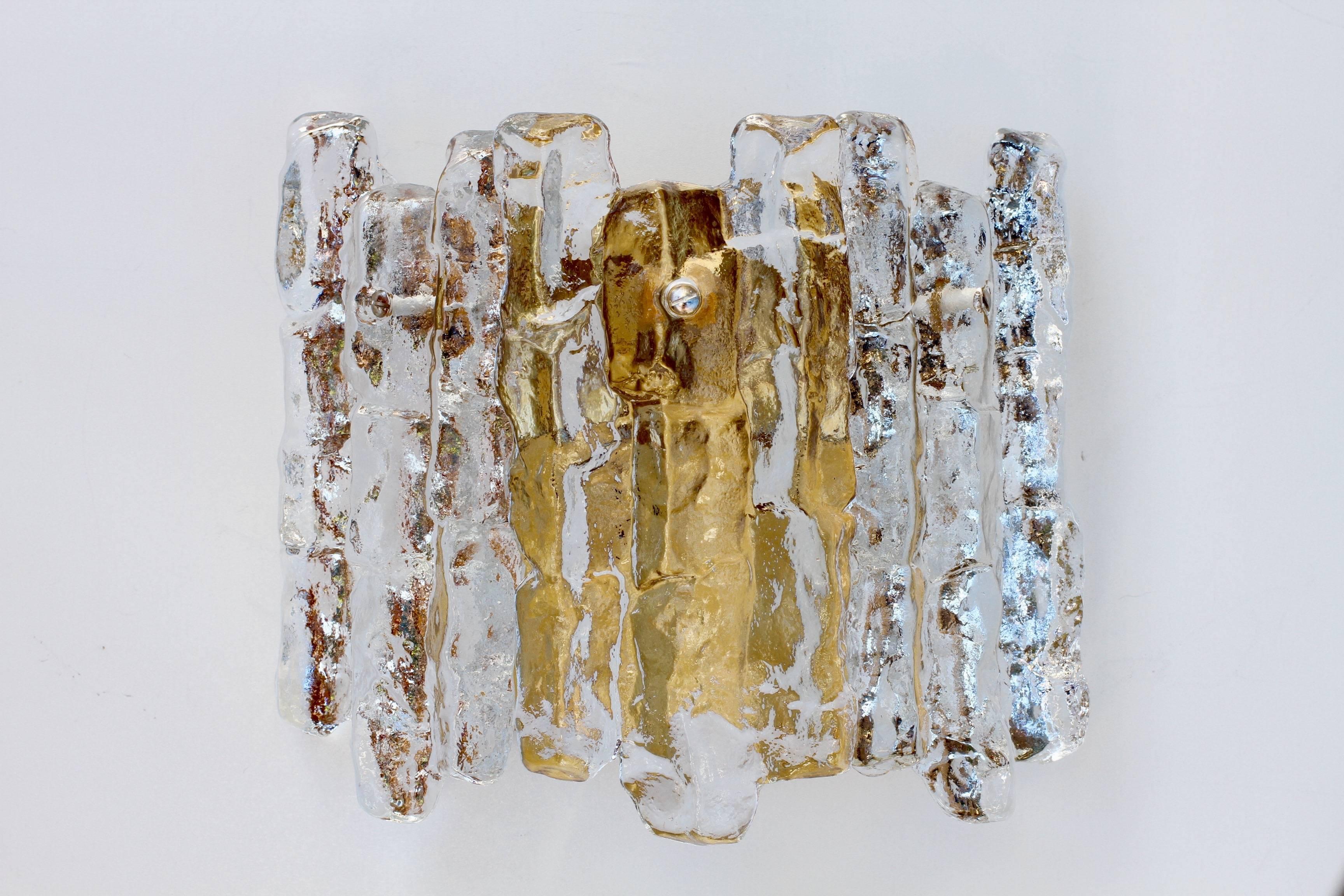 Exceptionally rare, one new old stock Austrian made ice glass wall sconce by Kalmar, circa 1960. Featuring three hanging glass elements resembling melting ice crystals suspended from a Gilt brass mount or bracket.

Can be used with original pull