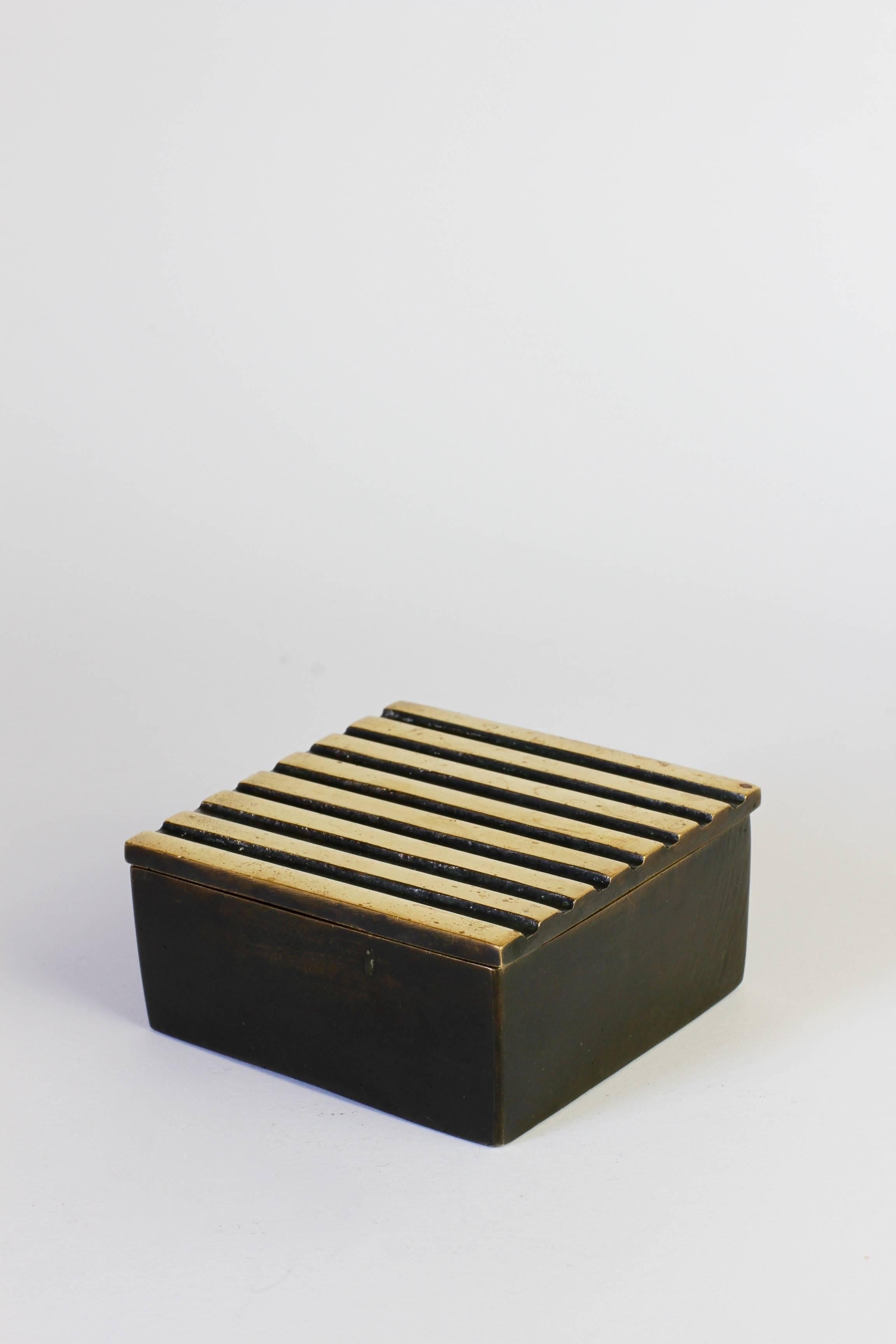 An extremely rare brass box or tin designed by Walter Bosse for storing cigarettes or tobacco in.

We have yet to find this example in any publication on Bosse's work although similar examples have been published including the matching matchbox